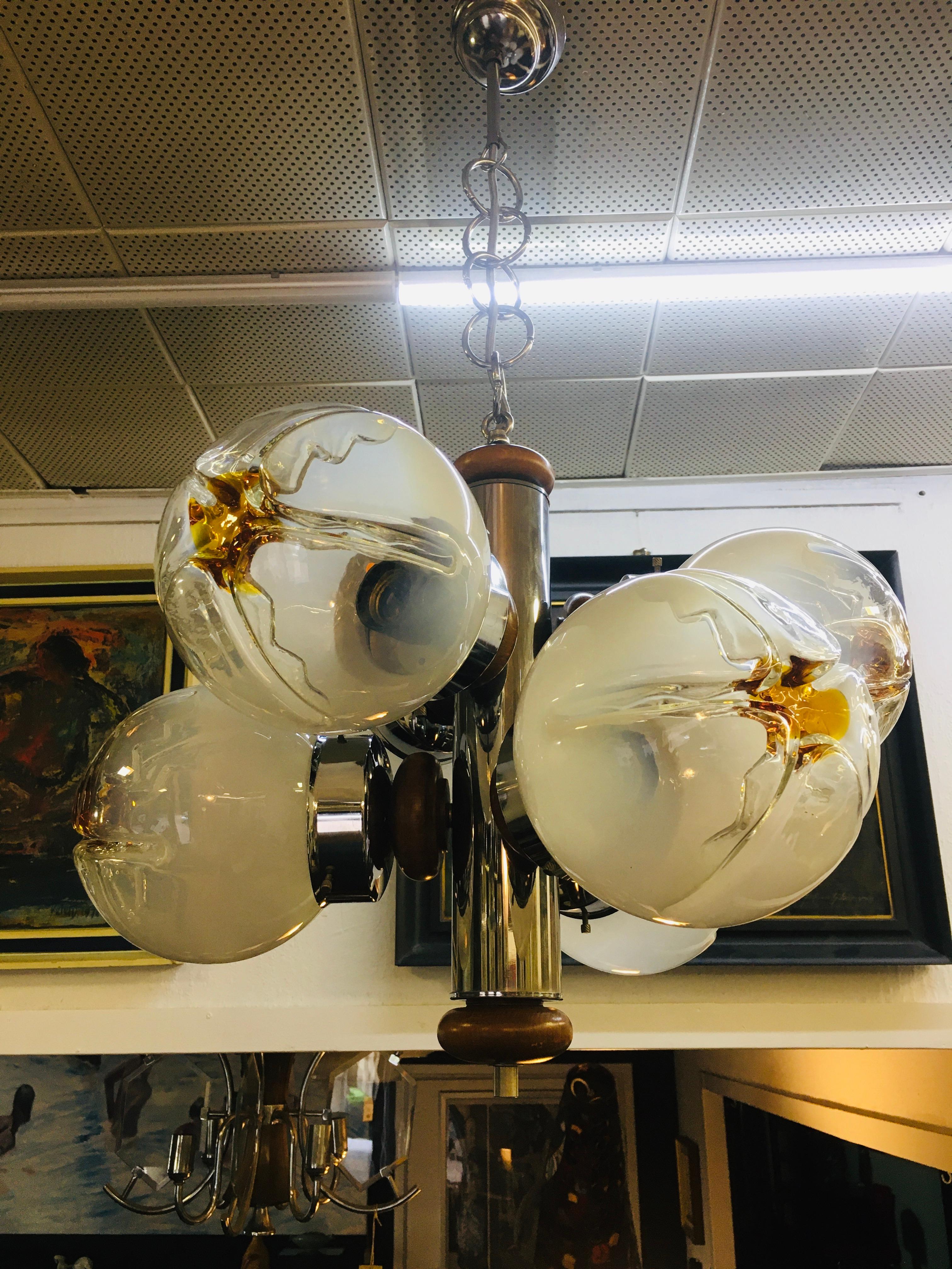 Vintage chandelier with chrome frame and glass shade from the Italian glass manufacturer Mazzega in Murano. Mazzega's unique, petal-like glass hood design fits perfectly with the spacious frame. Due to the low height of the lamp, it can be used well