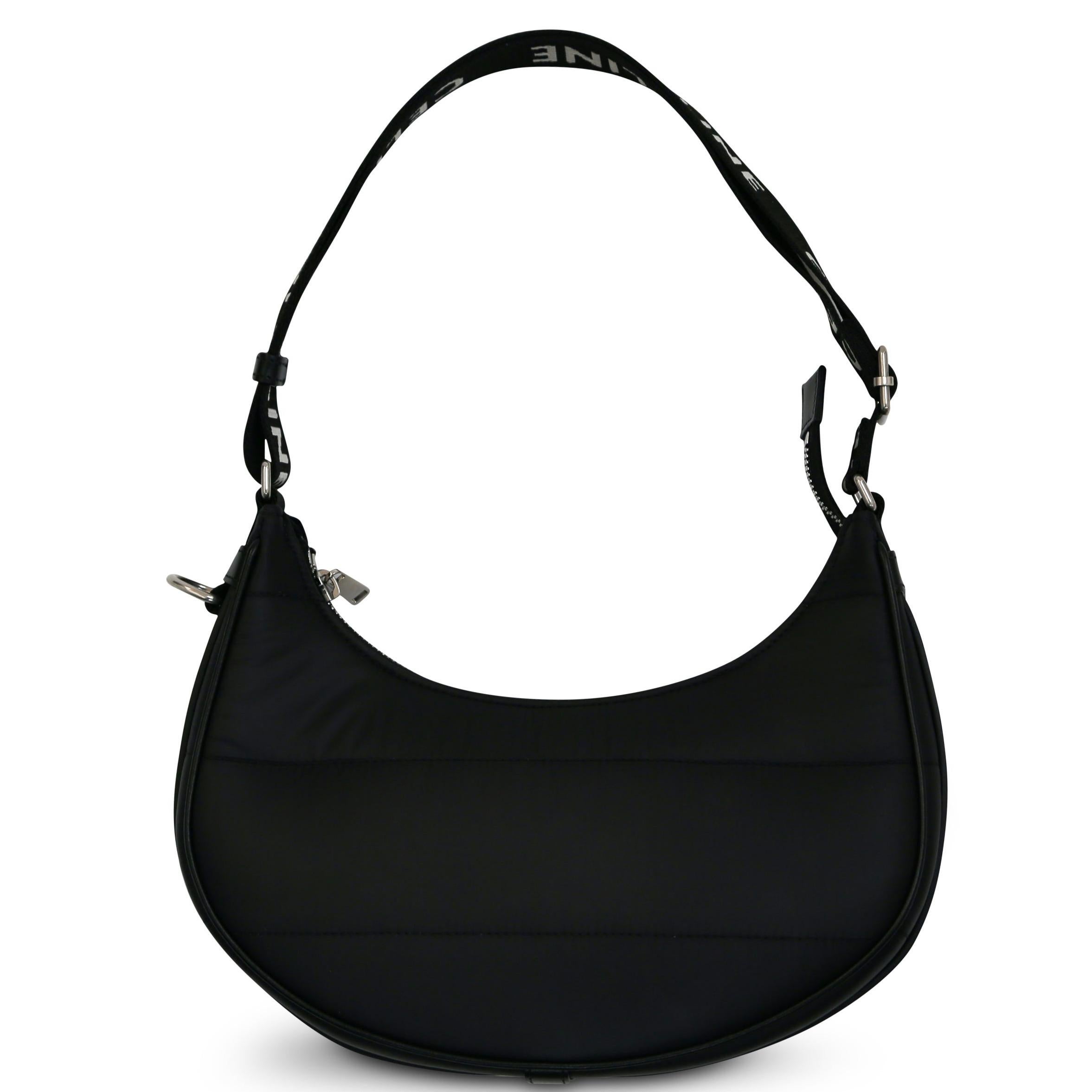 This chic black nylon bag with black leather trim has an adjustable strap and silver hardware. This bag is perfect for any occasion. Keep all your essentials organized with the top zipper and interior pocket.

100% Nylon
Internal zip pocket
Includes