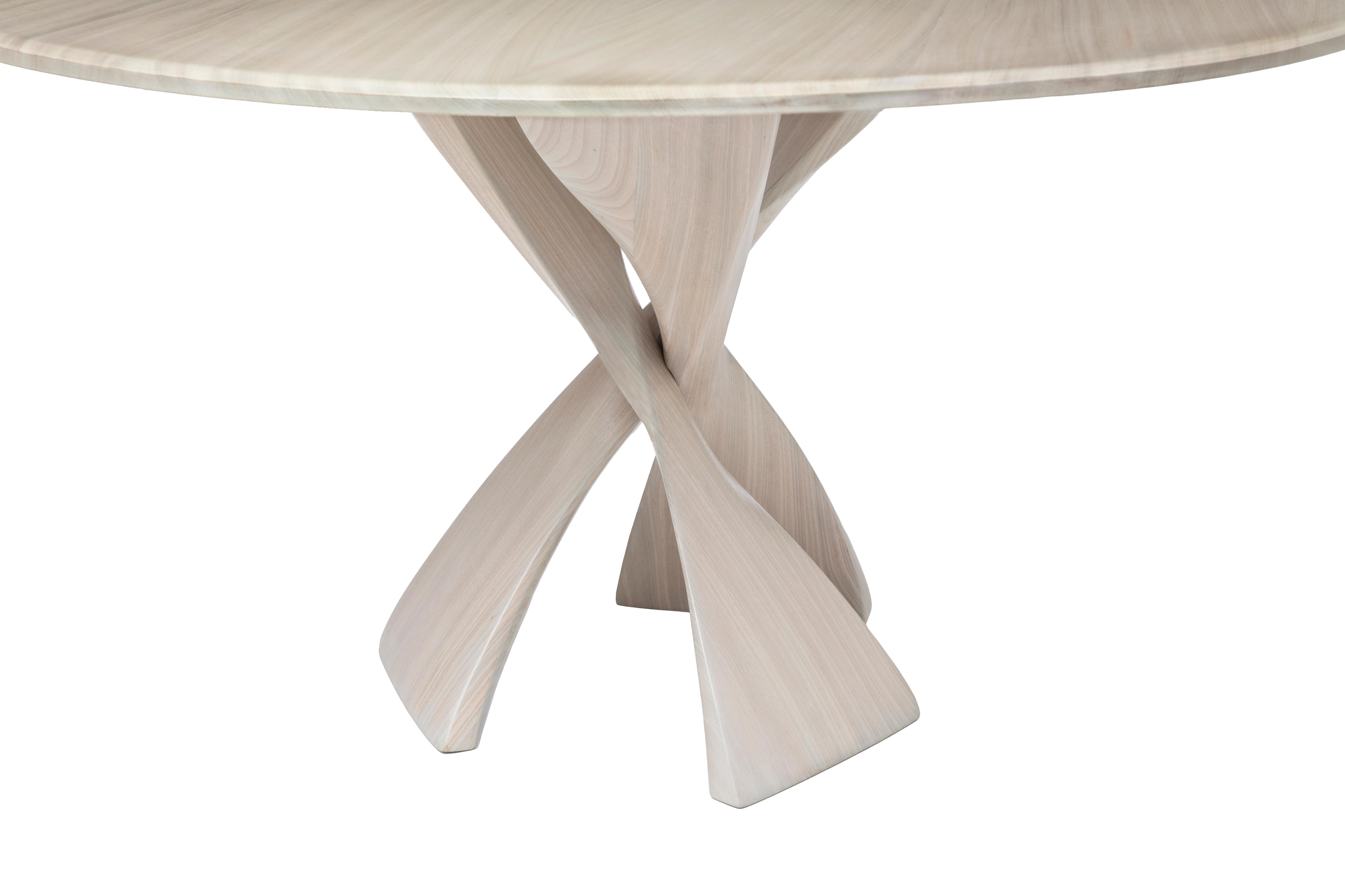 The AvA pedestal table is made up of three identical elements that twist around each other in a repeat pattern. The inspiration for the legs is reminiscent of The Evolution Stool design, also conceived and engineered by Vlad Krasnogorov. 
An