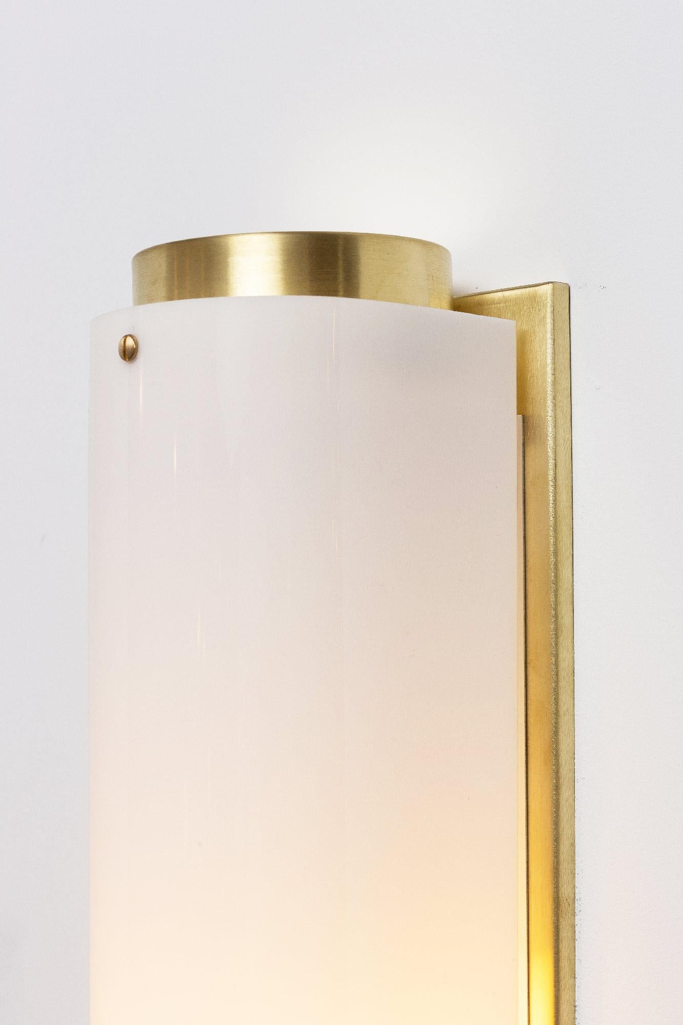 The arc sconce is made of a solid unfinished brass and backplate with a white Lucite shade and brass screws.

Small in inventory now: W 4.5in (13.5cm) x D 3.5in (13.5cm) x H 12in (30.5cm)
Brass

(2) 60W medium base socket
Satin brass and white