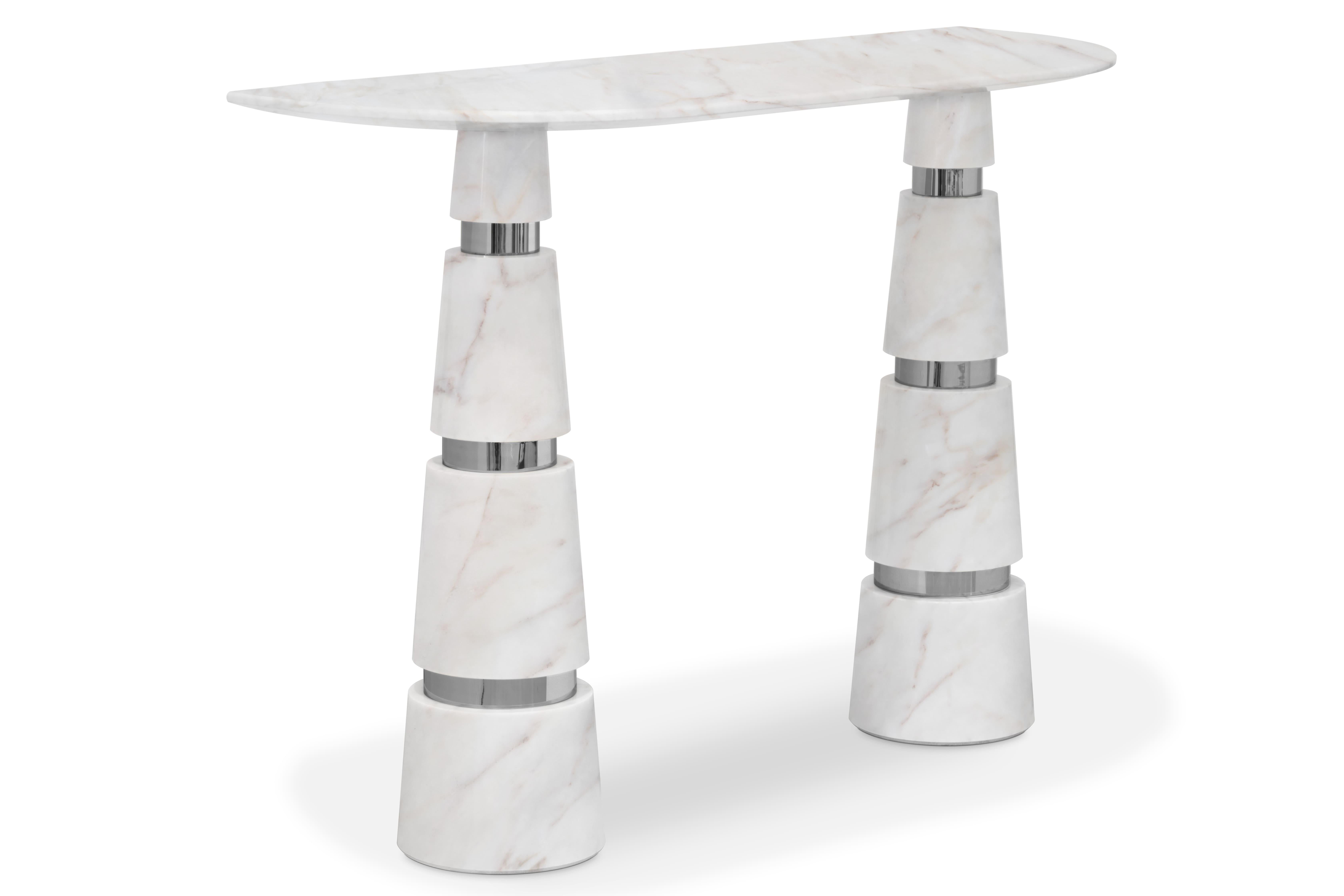 Drawing you in with a luxurious white marble and striking conal legs, the Avalanche Console is an icon of contemporary style. The modern shape and elegantly bright whites will bring your interiors into the future, where everything is sleek,