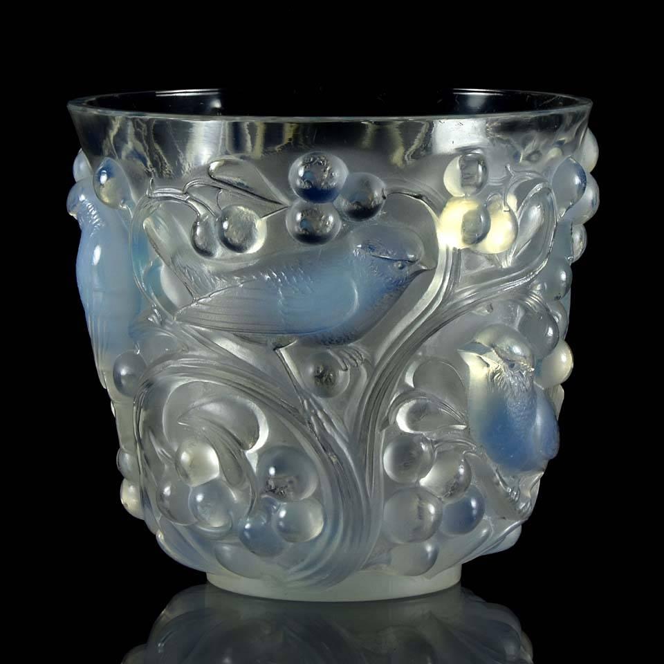 Most impressive clear, frosted and opalescent glass vase decorated with raised figures of birds on branches. A fabulous Art Deco design the surface of the vase has been finished by hand to accentuate the detail, signed on rim of base R Lalique,
