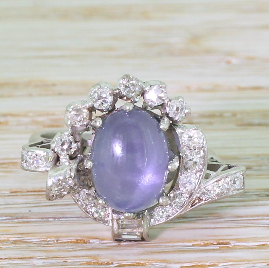 A ring this is as wacky and it is wonderful. At the centre sits a large purplish blue natural Ceylon star sapphire – certified as having no heat treatment – that displays a clear asterism in sunlight. The stone is secured in an eight-claw collet