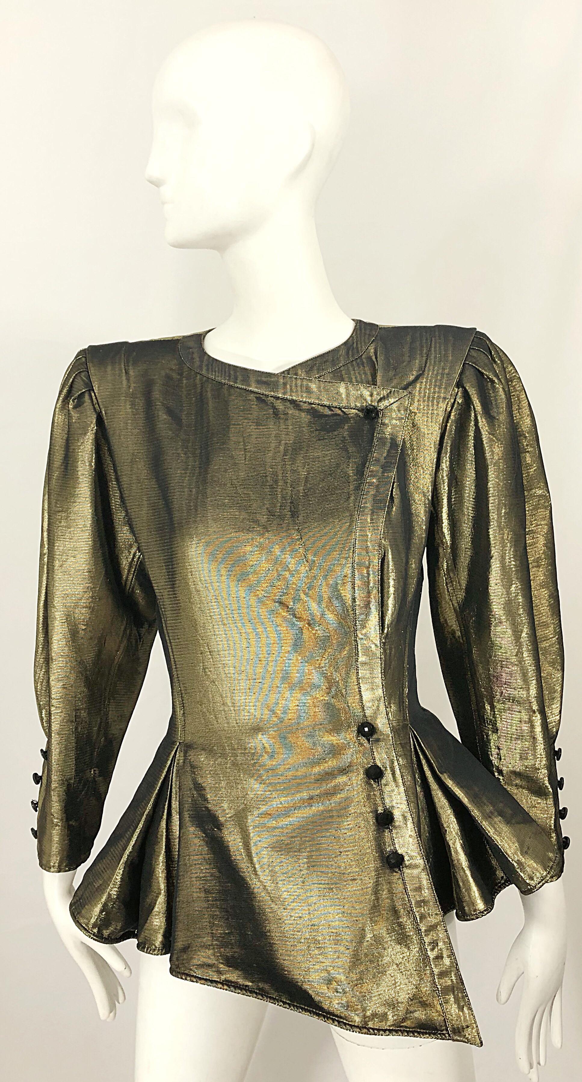 Insanely chic vintage late 1980s EMANUEL UNGARO gold silk metallic peplum jacket! Features strong shoulders with built in shoulder pads. Black lacquer buttons up the left waist with hidden interior buttons. Fully lined. Great layered or alone. Can