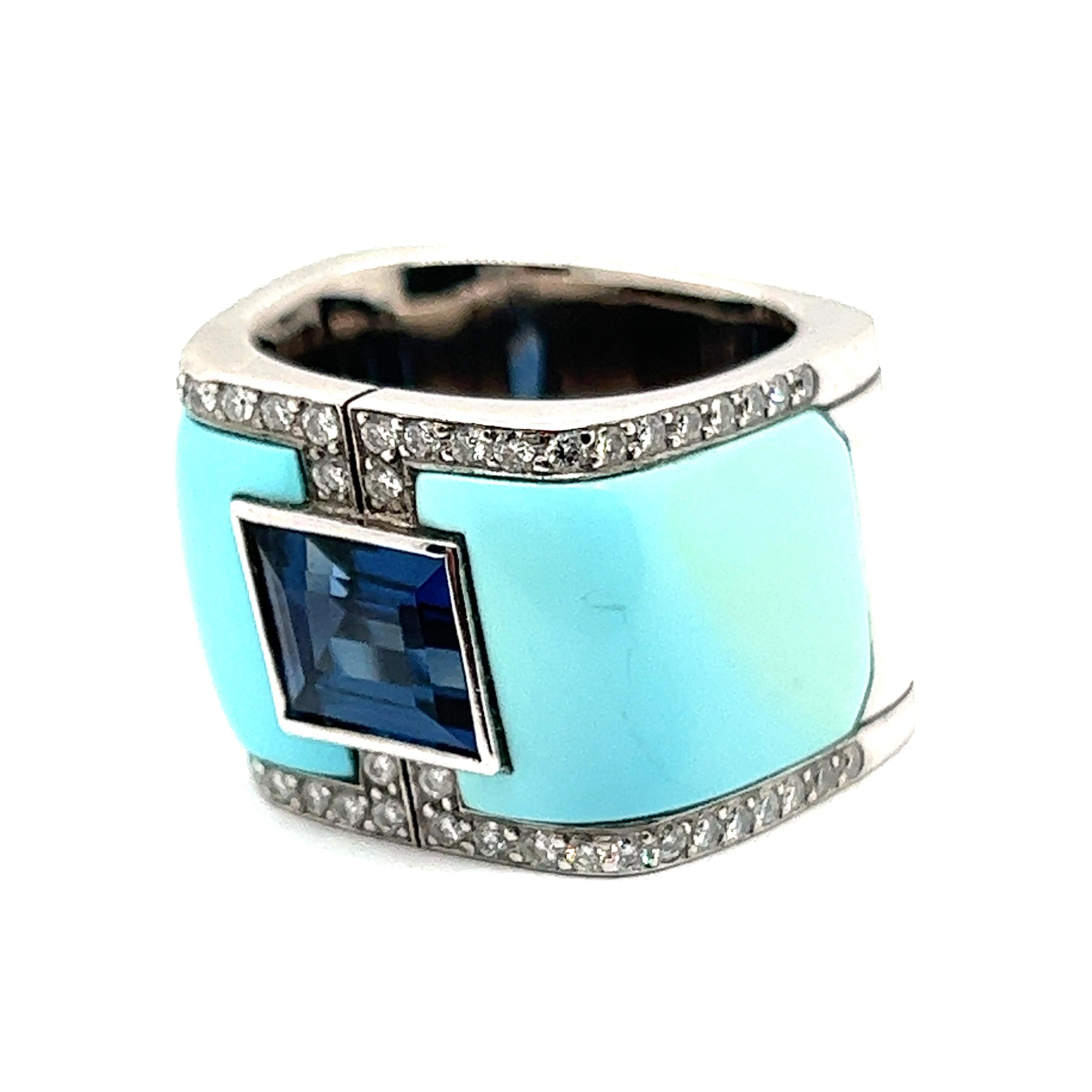 This avant-garde ring from the Swiss jeweler Binder highlights unparalleled artistry and creative design.

Created from 18 Karat white gold, the band serves as a canvas for a captivating 2.86 carat sapphire flanked by two turquoise gems. A halo of