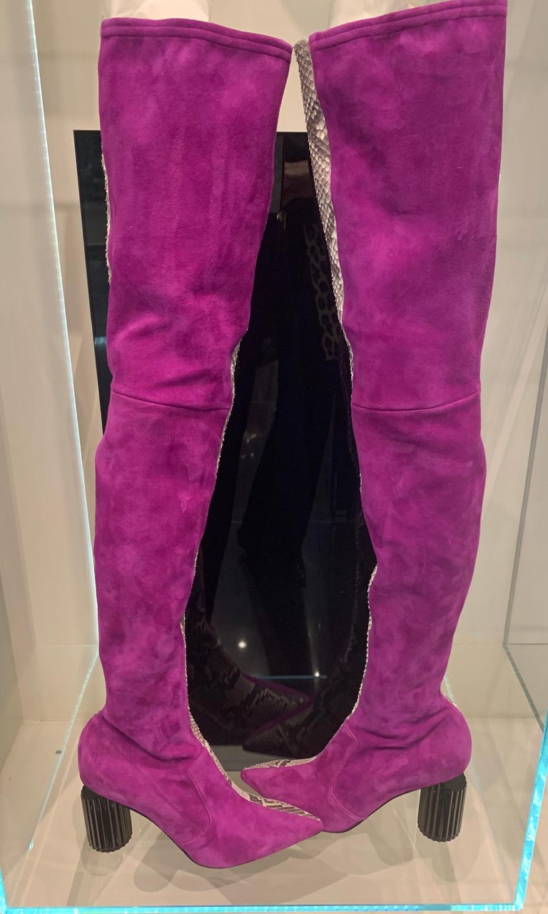Very avant garde, crafted from the finest leathers, breathtakingly fierce, Italian luxury brand, Roberto Cavalli, thigh high boots.  These edgy boots feature pointed toes, a split of magenta suede and snakeskin and a unique black circular fluted 4