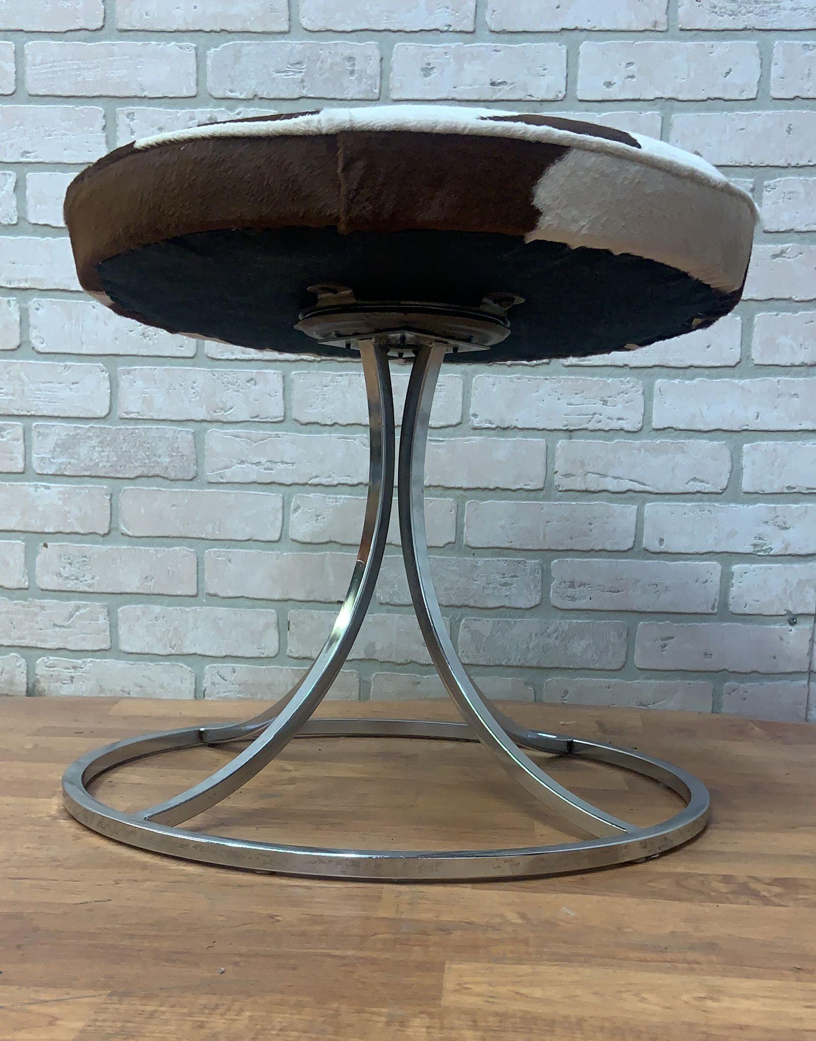 Mid Century Modern Avard Style Chrome Tubular Swivel Base Stools Newly Upholstered in Cowhide - Set of 4

Stunning set of mid century modern Avard style chrome squared tubular round cushion top swivel vanity/accent stools. Each stool has been newly