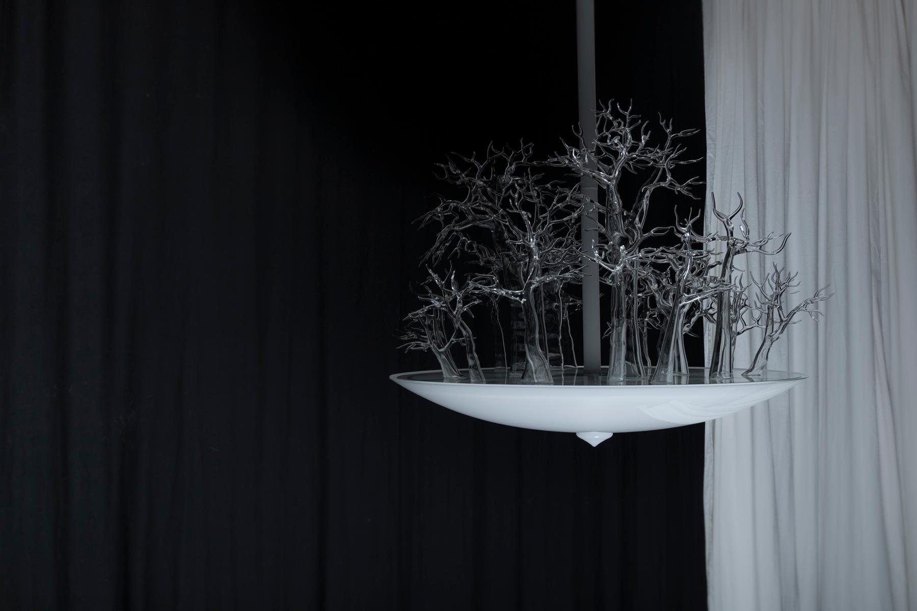 This chandelier demonstrates the true versatility of glass. Through
scale and material, trees are transmuted into objects of delicacy. The harmony of a dense thicket of trees is contrasted by the lightness of reflective glass. 


Duetto is a