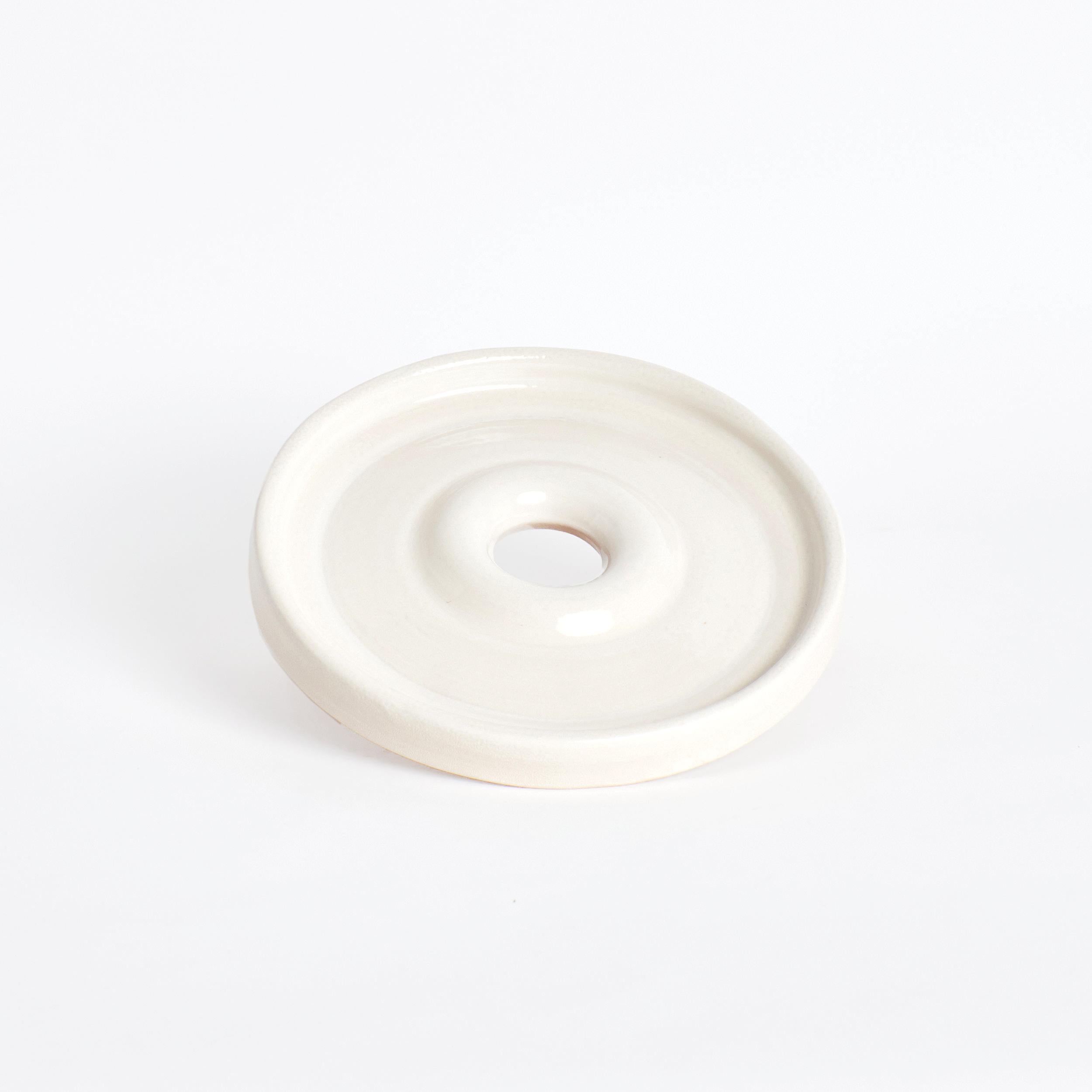 Aveiro Plate in Cream by Project 213A
Dimensions: D 28 x W 28 x H 3 cm
Materials: Ceramic. 

This plate is hand crafted and sculpted on a ceramic wheel. Finished with a hole in its centre the plate arranged the food placed on it playfully around