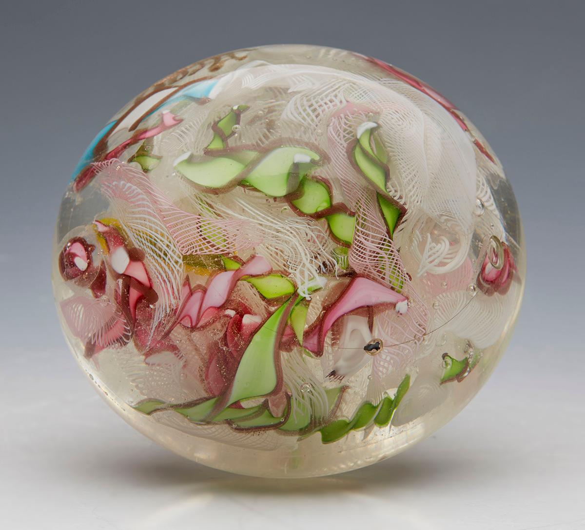 A large and impressive vintage Italian Murano glass paperweight made by Arte Vetreria Muranese (A.V.e.M.) and dating from around 1935. The large hand blown domed clear glass paperweight contains scattered coloured twisted ribbons and muslin canes