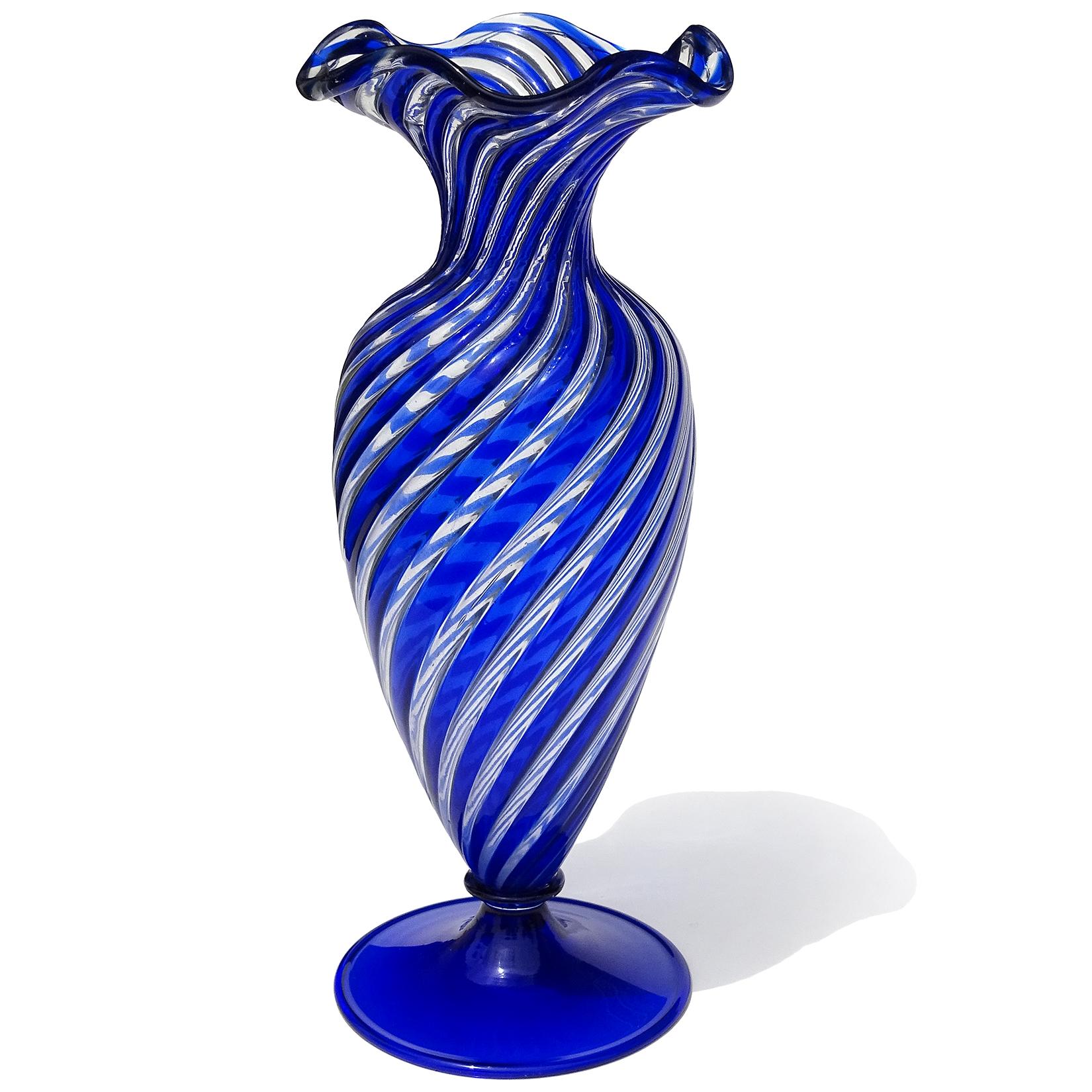 Beautiful vintage Murano hand blown sapphire blue and clear Italian art glass footed flower vase. Documented to the Arte Vetraria Muranese (A.Ve.M.) company. The vase is created in the “A Canne” technique, with blue and clear rods of glass