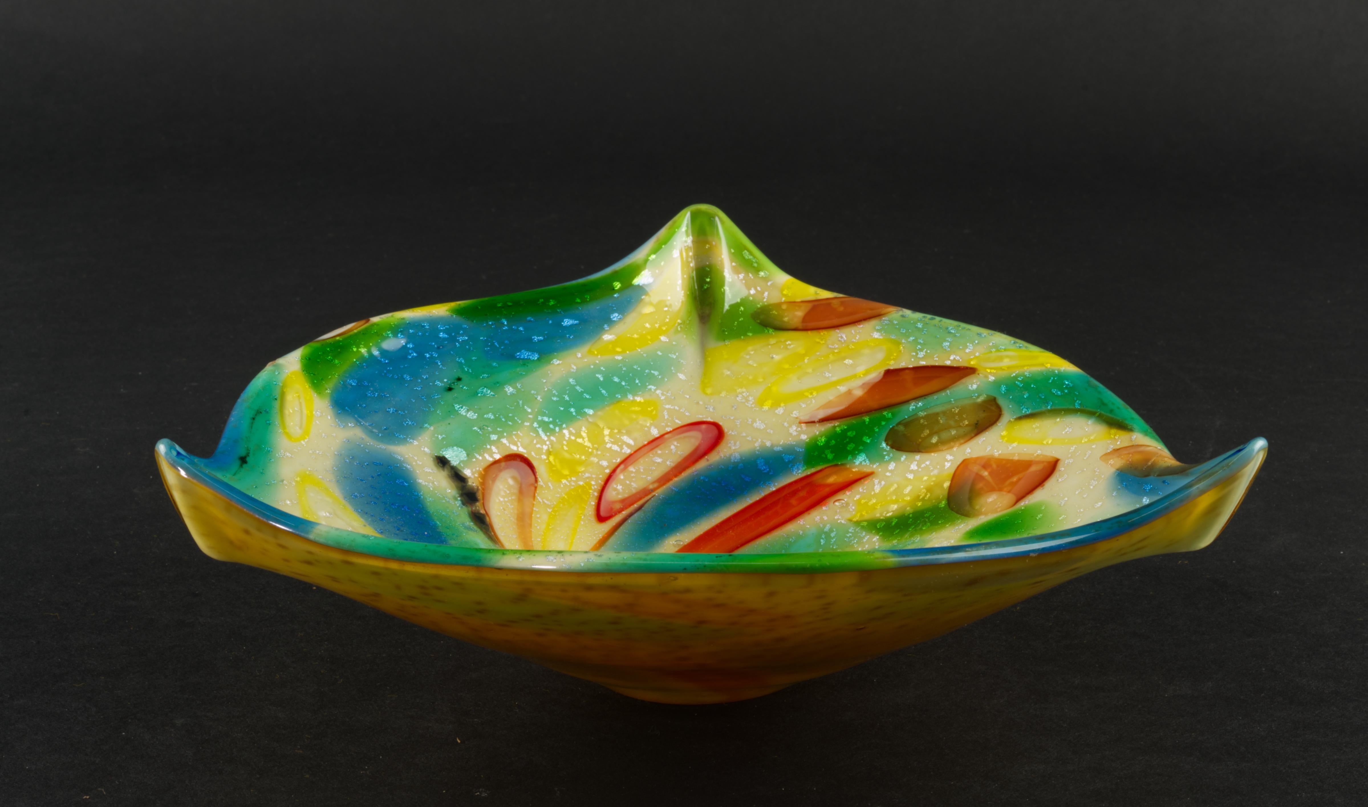 
Murano glass free-form bowl or ashtray with 3-way crimped rim was made in 1950s in Italy by AVEM (Arte Vetraria Muranese). It has typical tutti frutti poly-chrome interior with mixture of murine in colorful swirls and silver leaf inclusions and