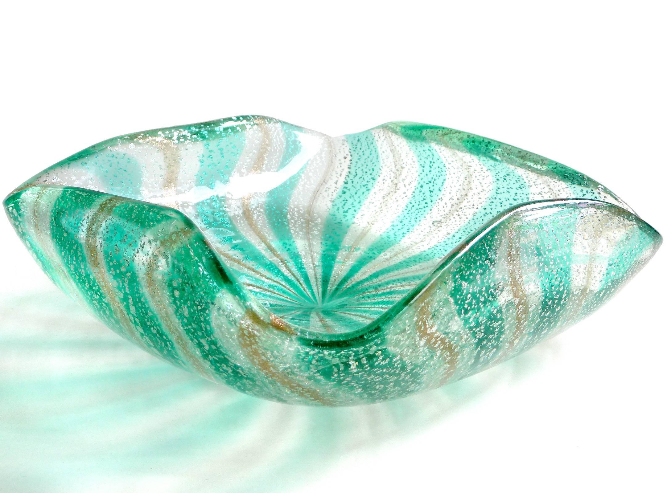 Beautiful vintage Murano hand blown green, copper aventurine and silver flecks Italian art glass bowl. Documented to the A.Ve.M. (Arte Vetraria Muranese) company. The piece has alternating bands of green and acenturine over silver leaf. It has a