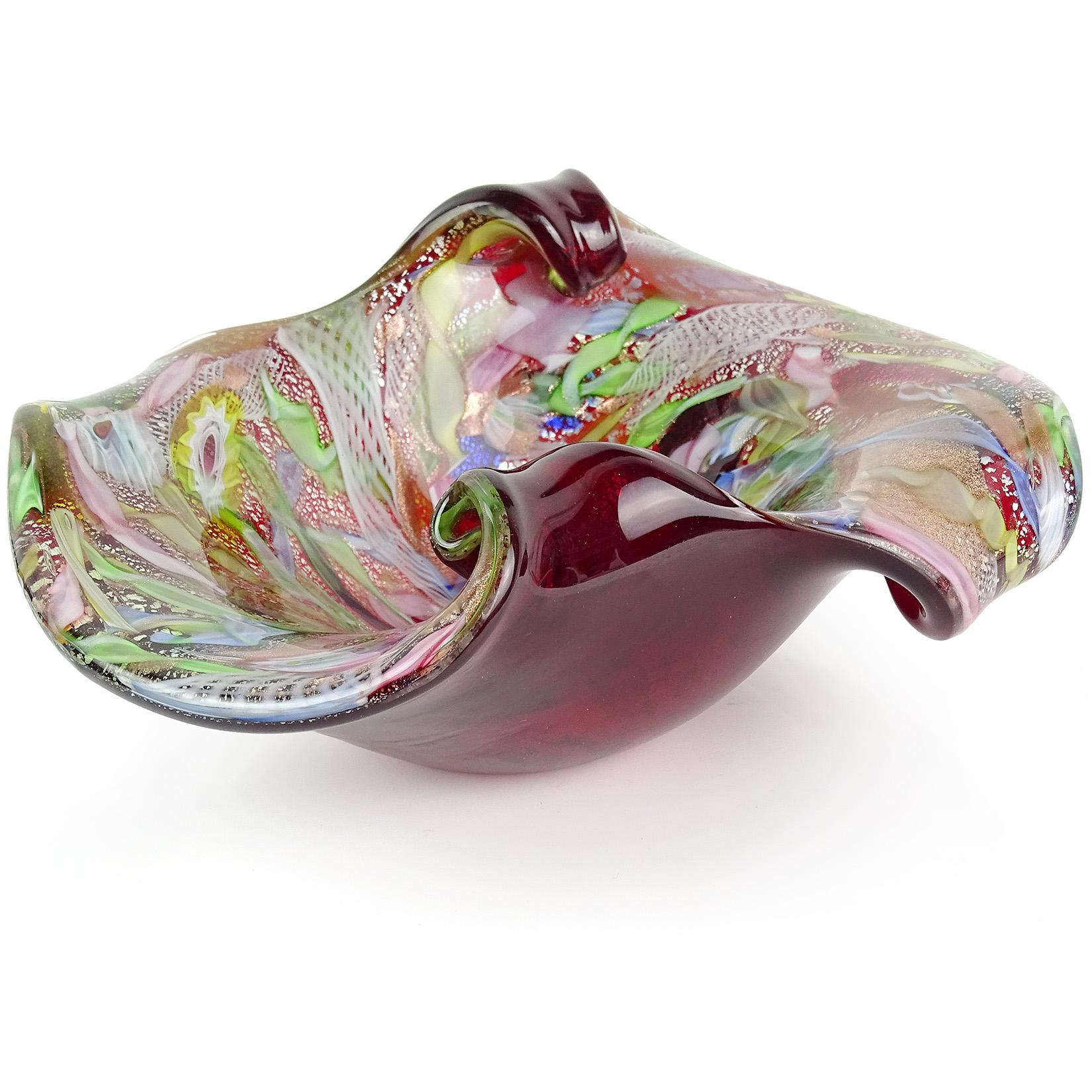 Beautiful Murano hand blown red, silver flecks, copper aventurine, millefiori flower murrines and twisted ribbons Italian art glass center bowl. Documented to the A.Ve.M. (Arte Vetraria Muranese) company. The bowl has a scissor cut rim, with the