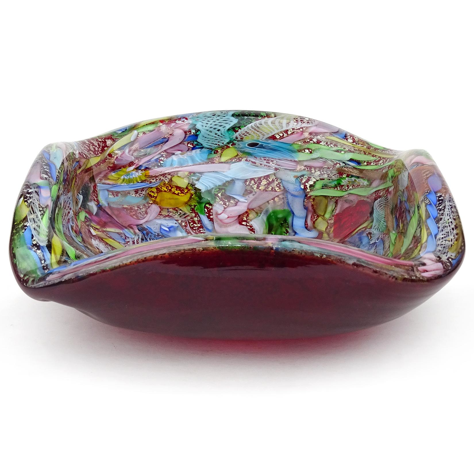 Beautiful vintage Murano hand blown red, silver flecks, copper aventurine, millefiori flower murrines and twisted ribbons Italian art glass bowl. Documented to the A.Ve.M. (Arte Vetraria Muranese) company. The bowl has a squared shape, with an