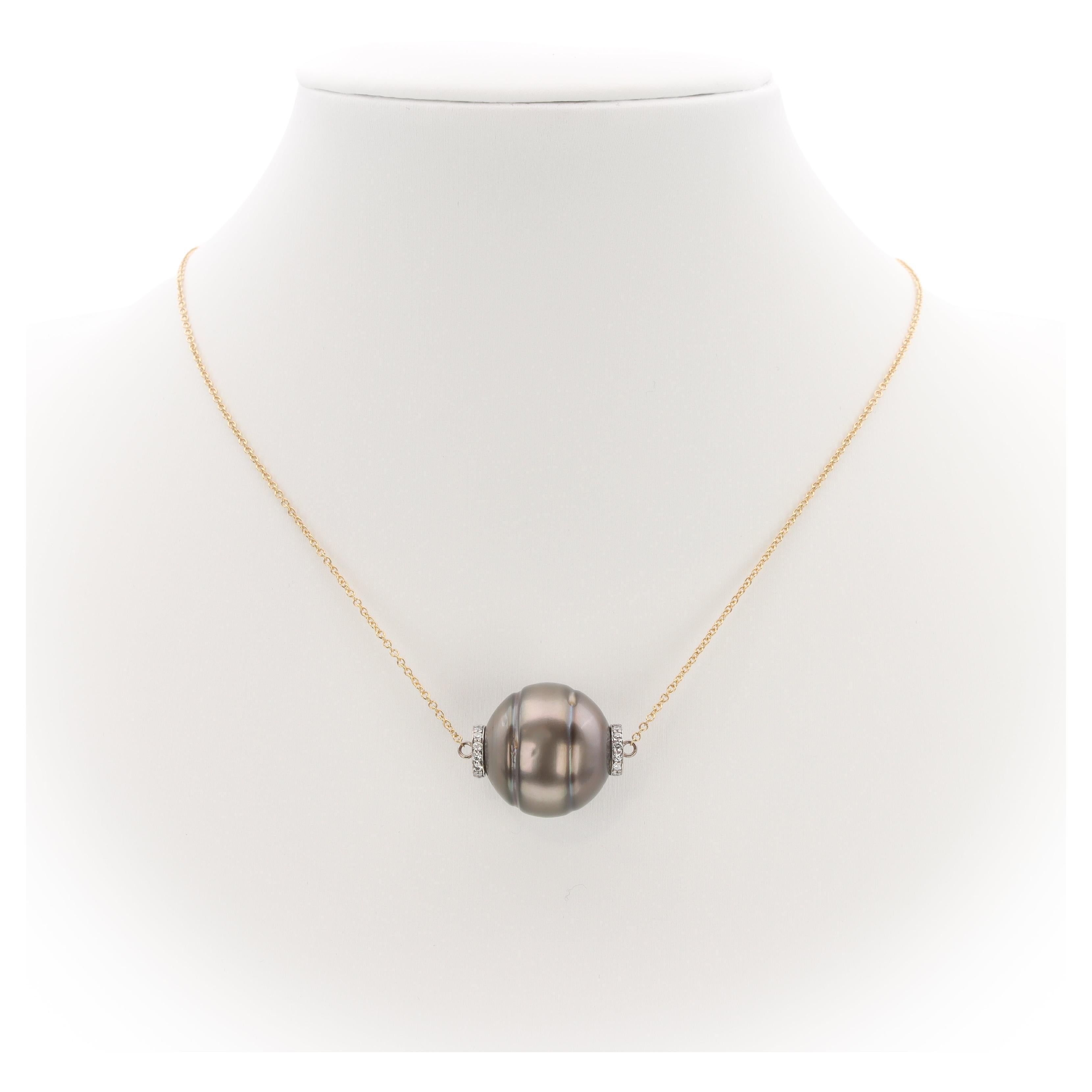 The 'Luna' Necklace is a one-of-a-kind creation by Aventina-Spencer featuring an 16.3mm symmetrically Circled Marc'Harit Conscious Tahitian Pearl accented by 0.13 carats of round brilliant cut diamonds (G/VS) expertly set in 18K recycled white gold.