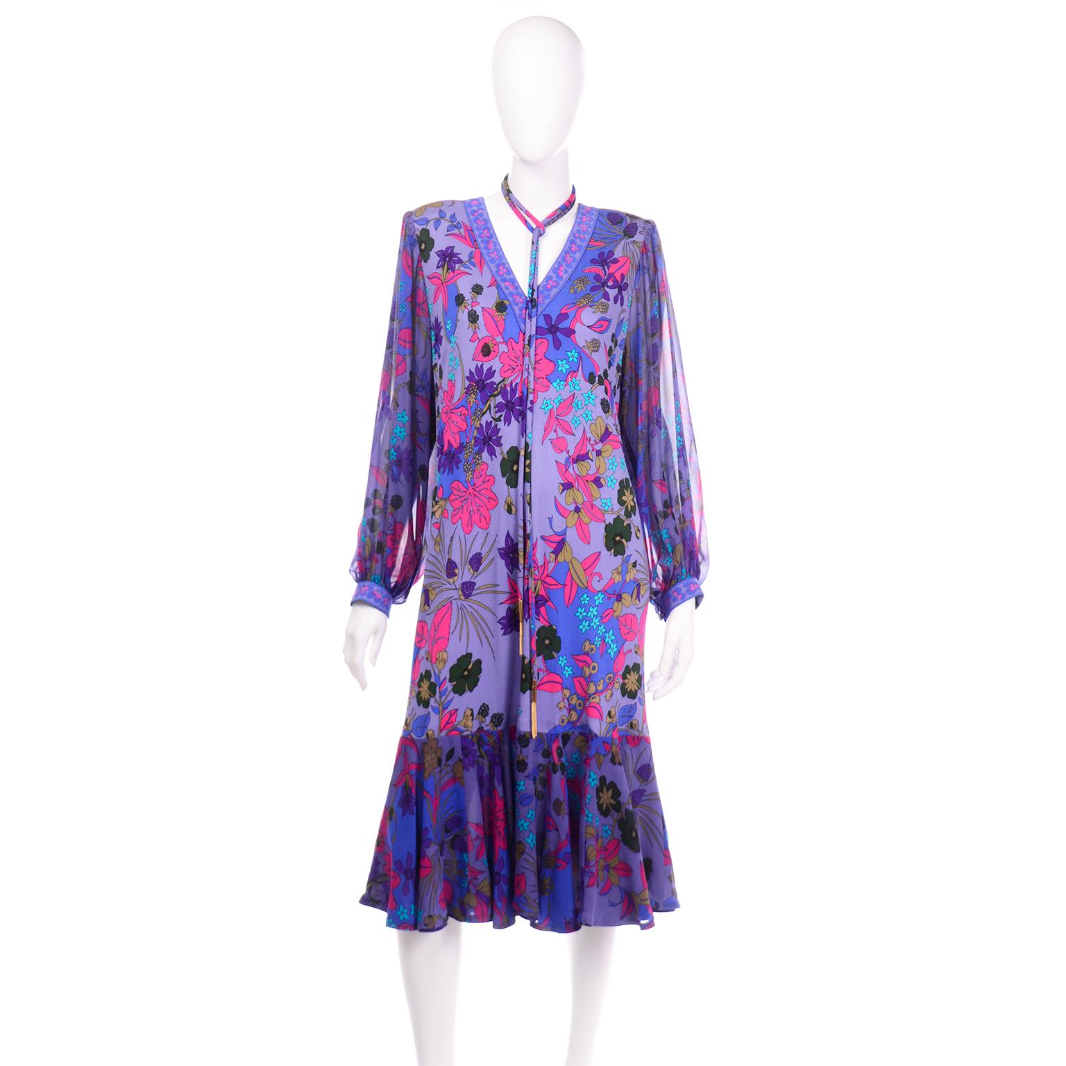 This beautiful vintage 100% silk Averardo Bessi dress is in a printed silk jersey in shades of violet purple, green, olive, magenta, blue, and teal. There is a metal zipper down the center back seam with a hook-and-eye for closure, The shoulders are