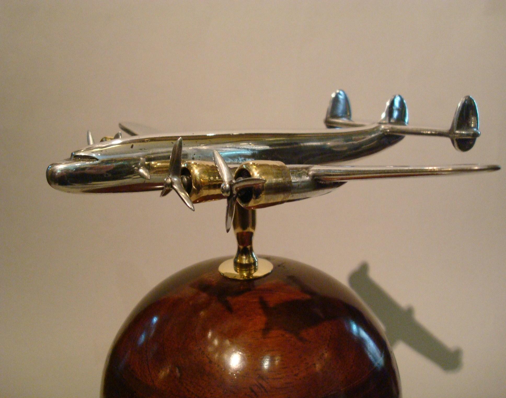 Aviation Lockheed Constellation vintage aluminium desk top display airplane model. The model has movement, you can change the position of the airplane. It has a mixture of Art Deco and midcentury design.
The Lockheed Constellation (