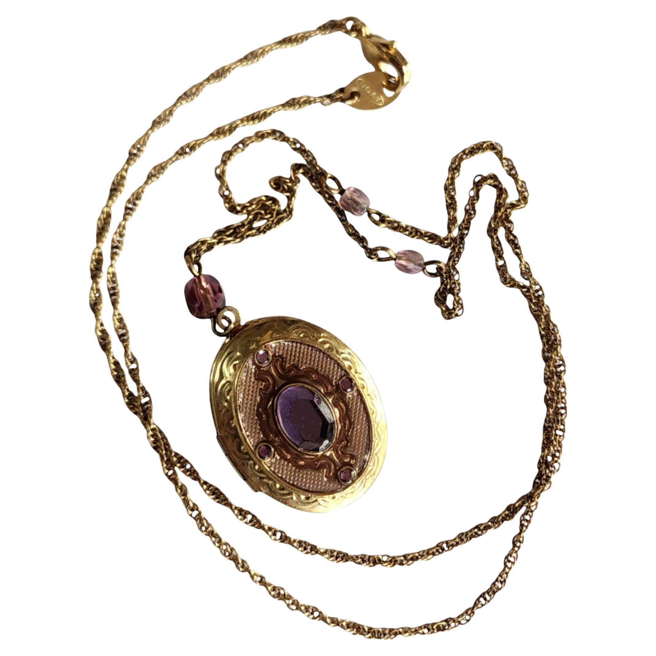 Avon 1970s Gold Tone Oval Locket Necklace with Purple Glass Accents For Sale