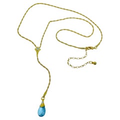 AVON vintage gold tone designer lariat necklace with blue briolette crystal drop