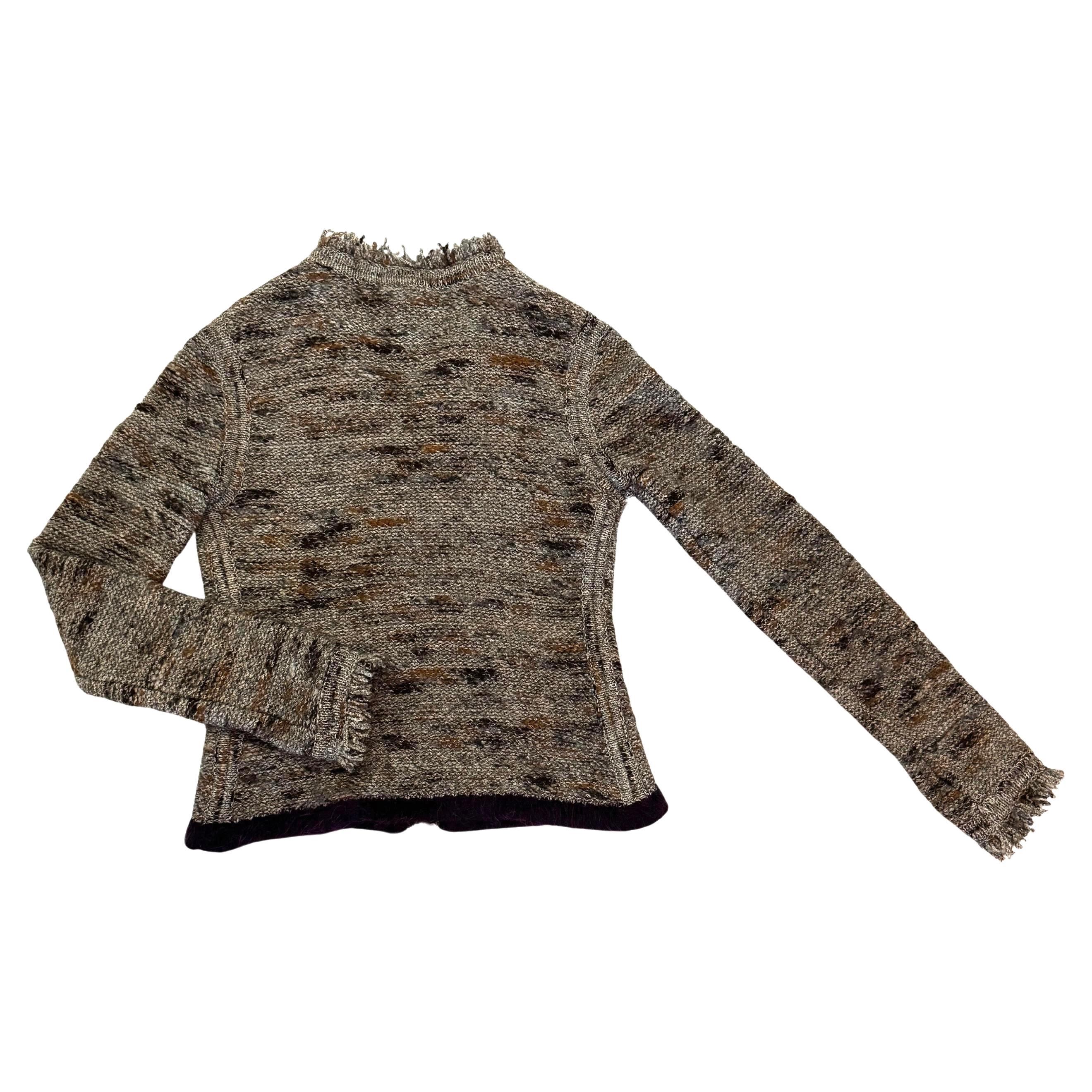 This vintage CHANEL cardigan is crafted of wool and nylon blended fabric in grey/brown/orange with a hem in purple featuring a buttoned front and two front pockets from the 1999 CHANEL Autumn/Winter collection. Made in France. Size FR