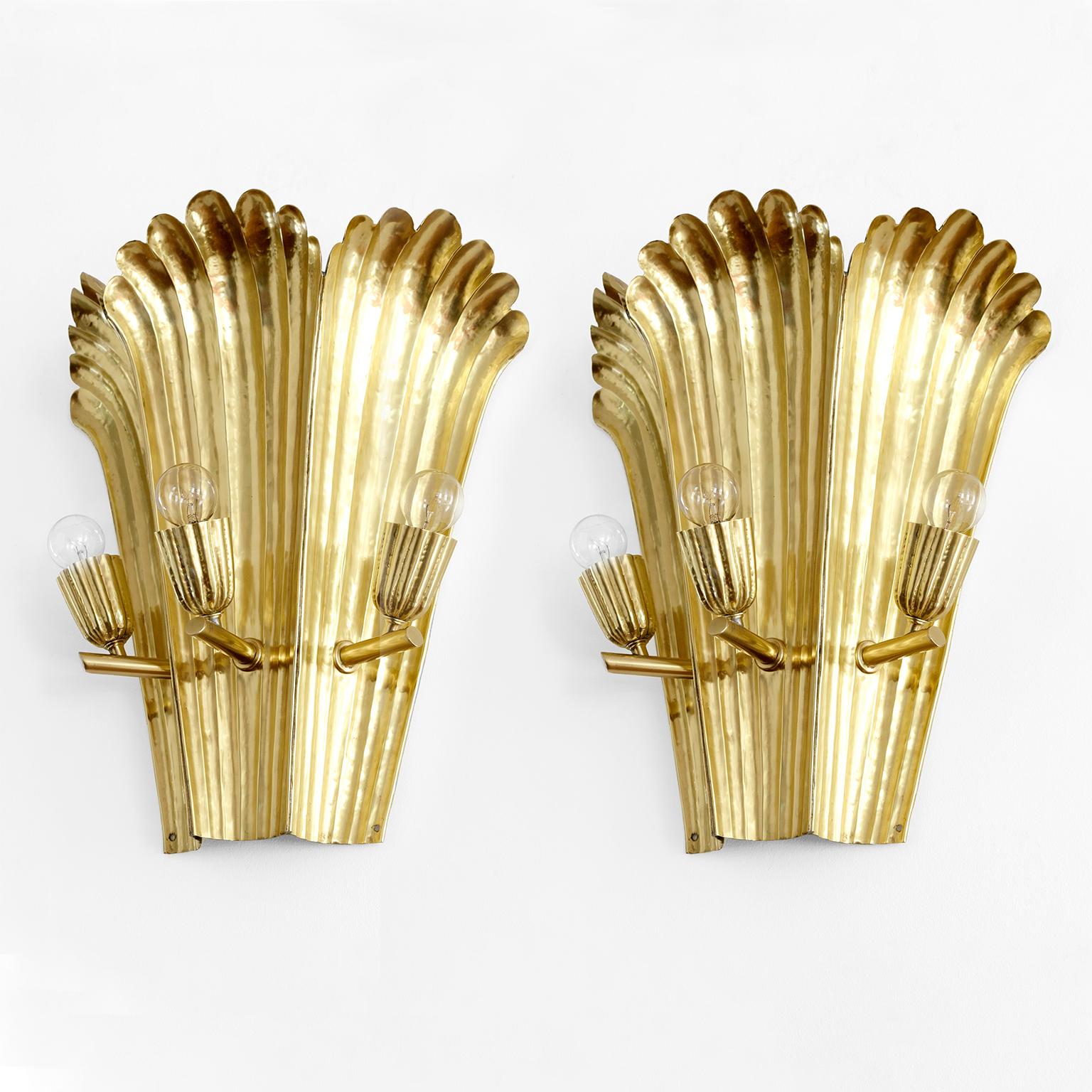 A.W Borgh designed pair (one of two available) Swedish Grace, 1920’s wall sconces. these were hand crafted and made of hammered brass. Each has 3 lights and uses candelabra base sockets. Newly wired for use in the USA, each sconce has a signed