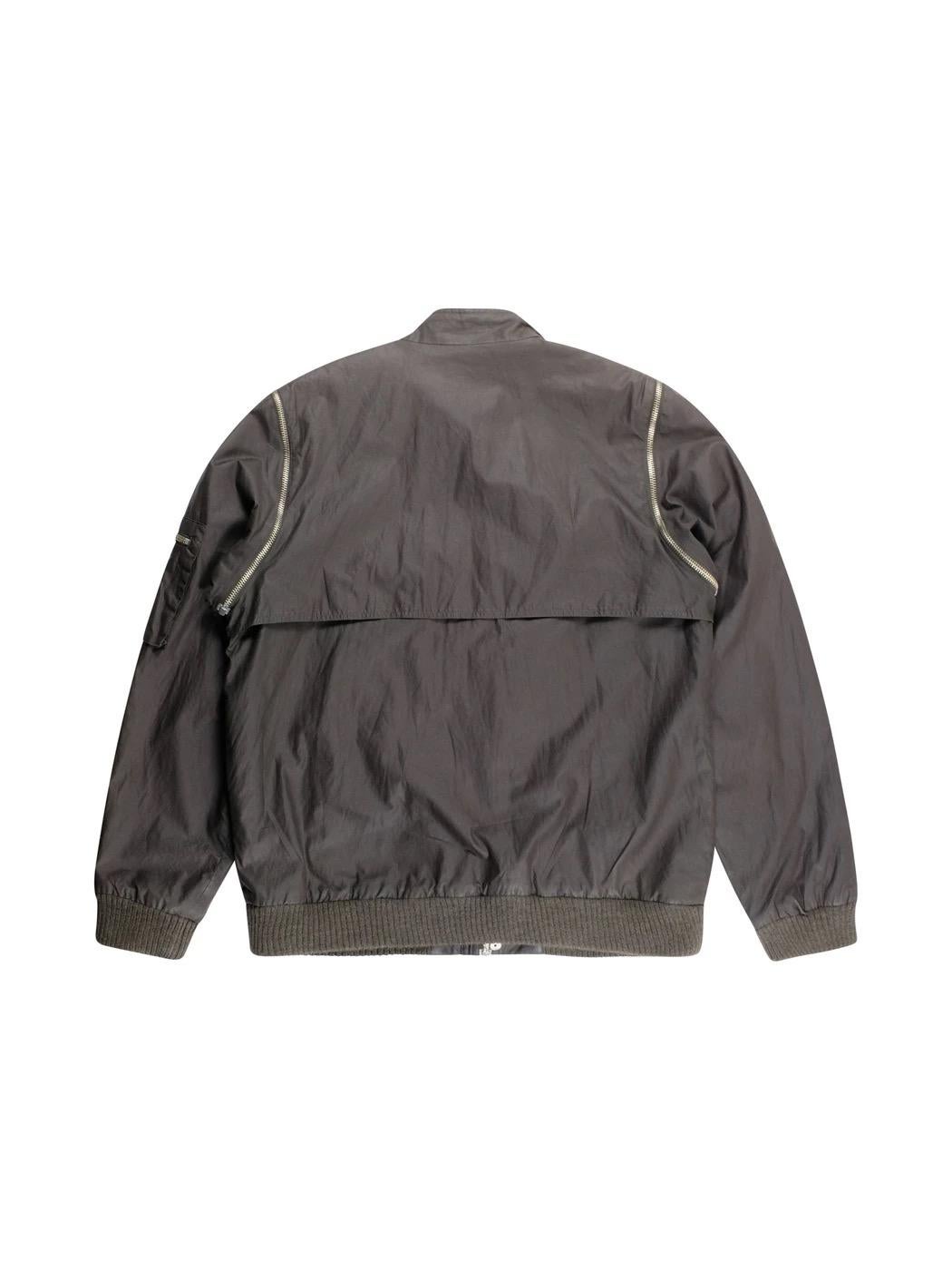 An absolutely legendary release from Raf Simon's AW01 Riot collection comes this very unique flight bomber jacket where the sleeves can zip off. Also features zip front pockets and a snap across the neck in true flight fashion. This is a true