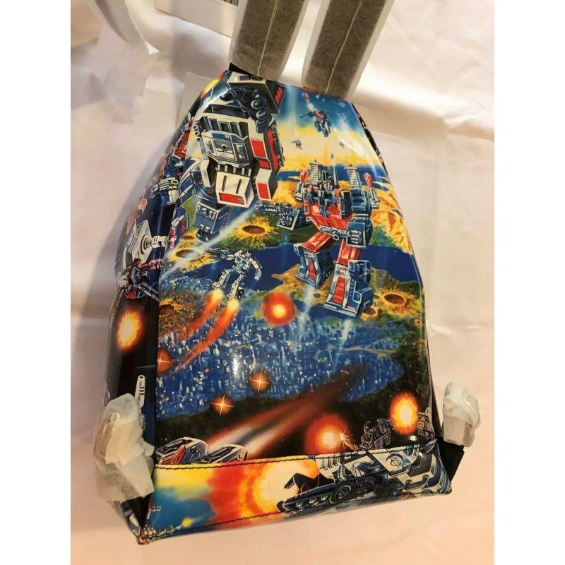 Gray AW17 Moschino Couture Jeremy Scott Transformers Blue Multi-color Print Backpack For Sale