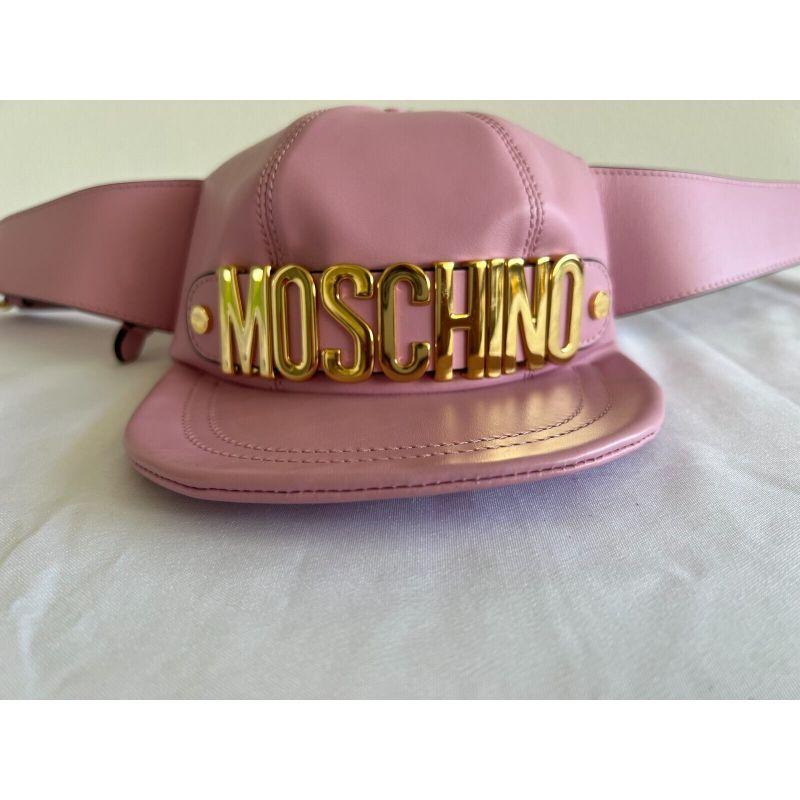 AW20 Moschino Couture Jeremy Scott Pink Leather Hat Shaped Fanny Pack Gold Logo

Additional Information:
Material: Leather
Color: Pink/Gold
Style: Belt Bag
Dimension: 8 W x 7 D x 4.7 H in
Year Manufactured: 2020-2029
Theme: Hat
Accents: Buckle,