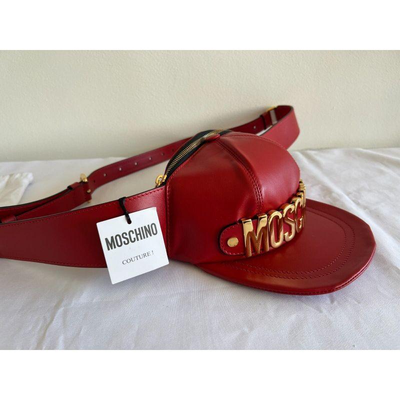 AW20 Moschino Couture Jeremy Scott Red Leather Hat Shaped Fanny Pack Gold Logo

Additional Information:
Material: Leather
Color: Red, Gold
Size: Medium
Style: Belt Bag
Dimensions: 8