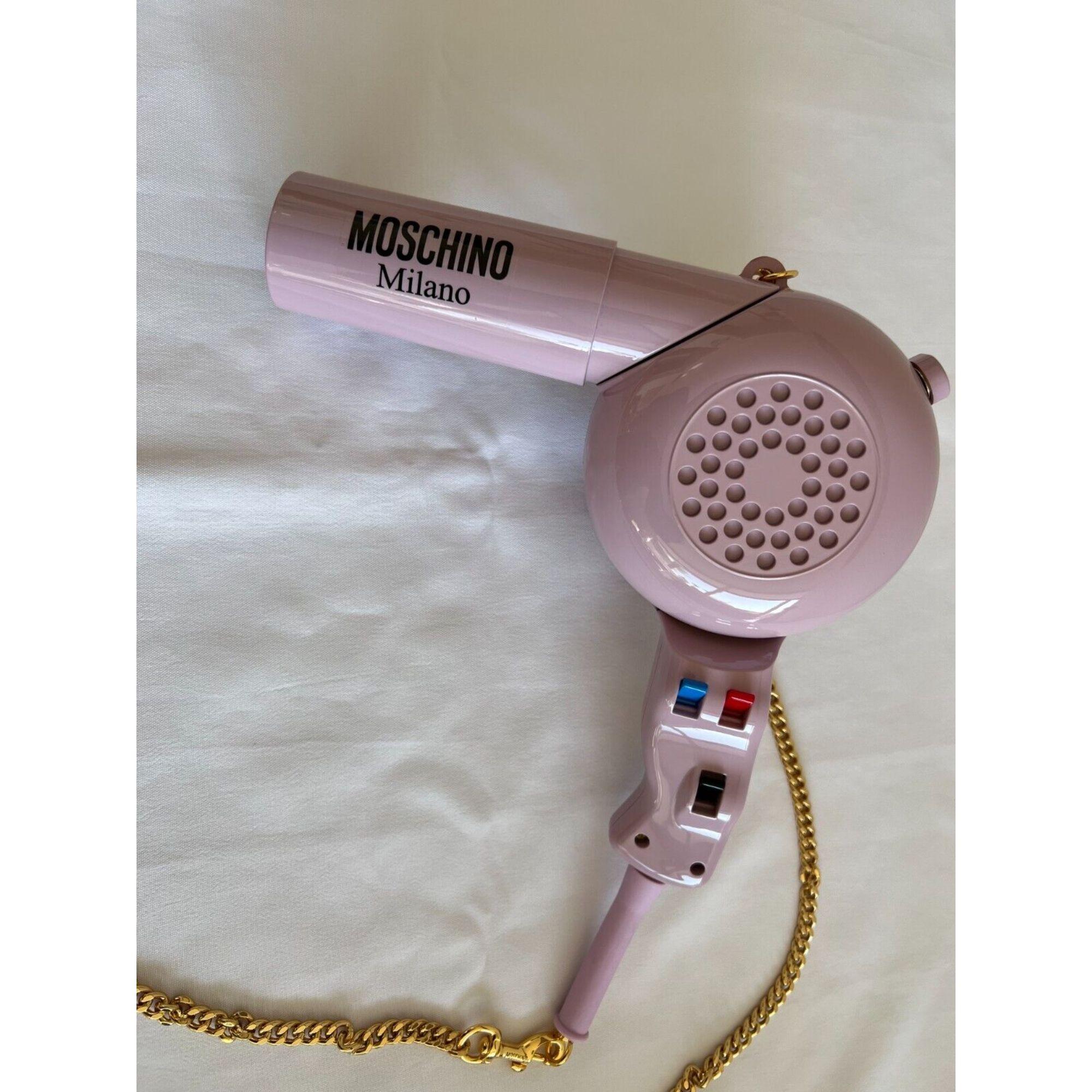 SEP SPECIAL! AW21 Moschino Couture Jeremy Scott Blow Dryer Mini Shoulder Bag

Additional Information:
Material: 100% Plastic
Color: Pink, Gold
Size: Mini
Pattern: Blow Dryer
Style: Shoulder Bag
Dimensions: W: 9.1”, H: 8.3”, D: 3.5”, the compartment