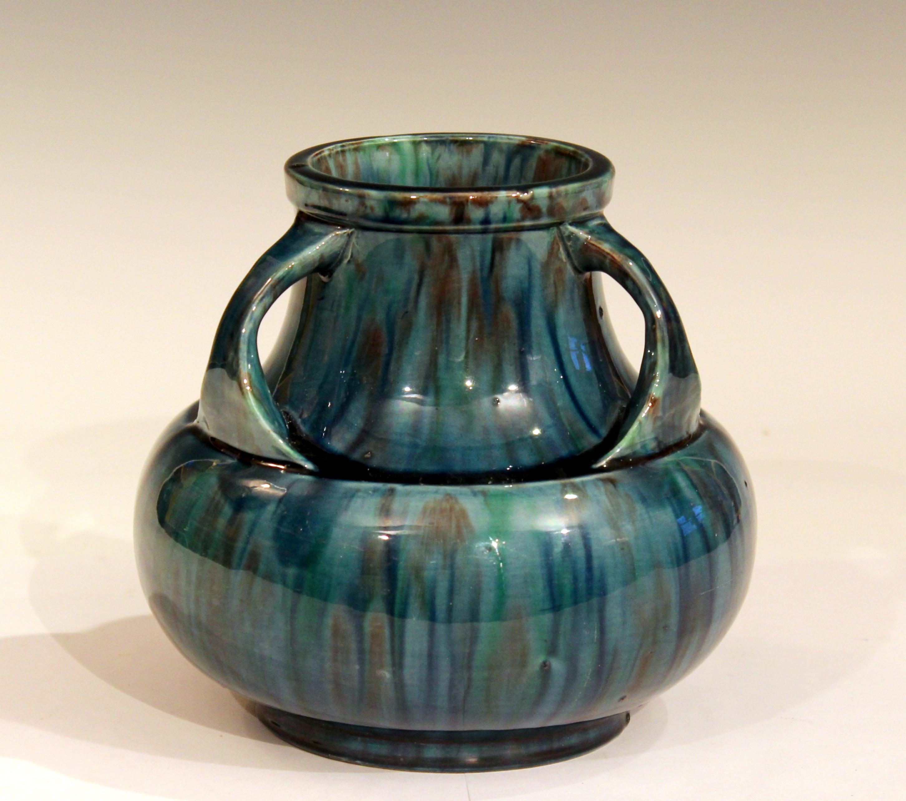 Awaji Pottery vase in Art Deco form with three handles curled over the wide, recessed shoulder and striking blue flambé glaze, circa 1930. Impressed marks. Measure: 6 1/2
