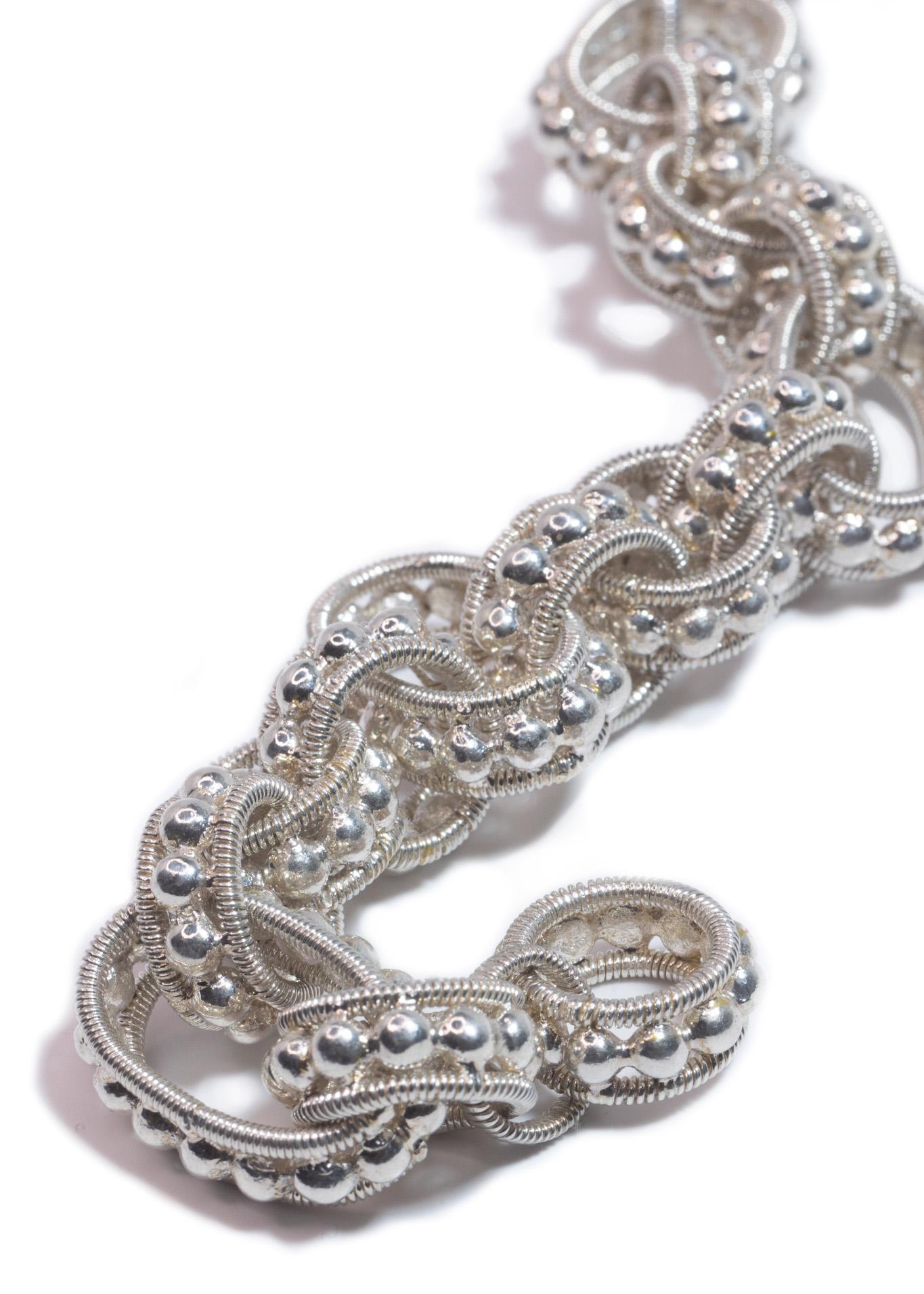 Intention: Glitz & Glam

Design: You're going to have fun jingling this argentium silver bracelet around town. The Awan bracelet has both oval and round links, each made up of small balls outlined with a tight spiral design.

Style Suggestion: Layer
