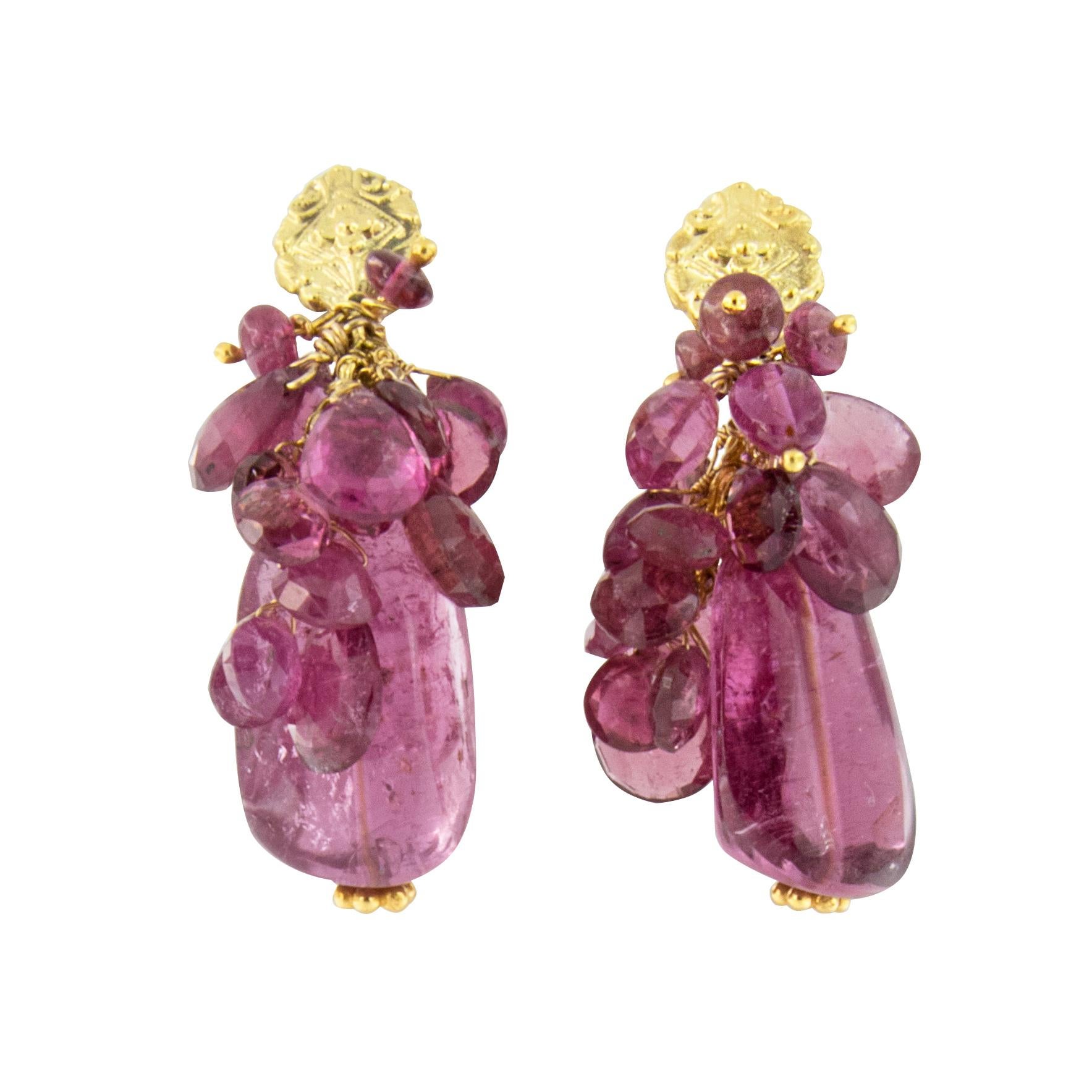 Make a statement with these beautifully hand-made 18 karat yellow gold dangle earrings with 84.42 Cttw of tumbled intense pink tourmaline drops individually wired for full movement. Designed and handmade by Susan Hoge. Susan Hoge’s work has been