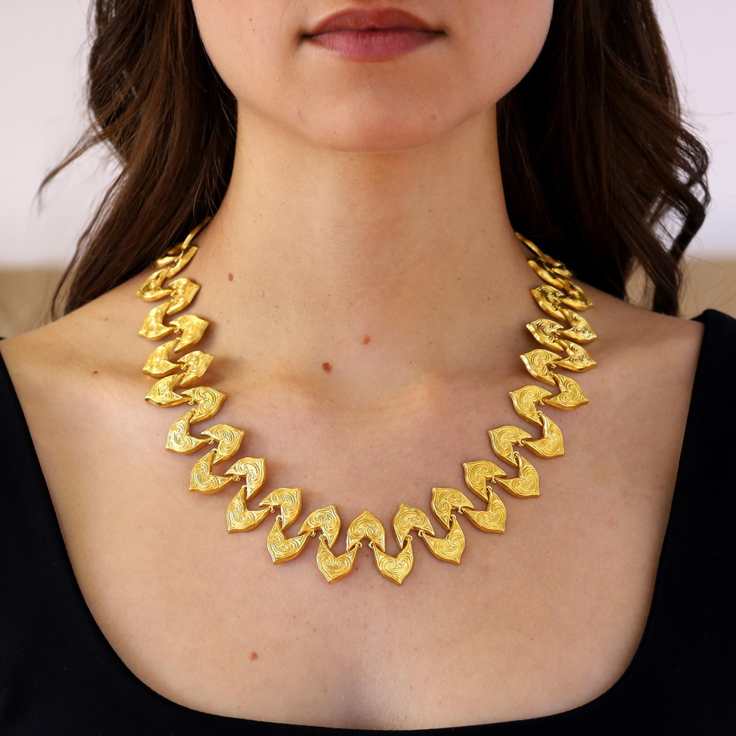 Featured in his 1984 book Metamorphoses, this stunning statement necklace by Ilias Lalaounis drapes seductively on your neck. We love the deep, rich color and tone of the high karat 22k gold highlighting the intricately designed ivy leaf links of