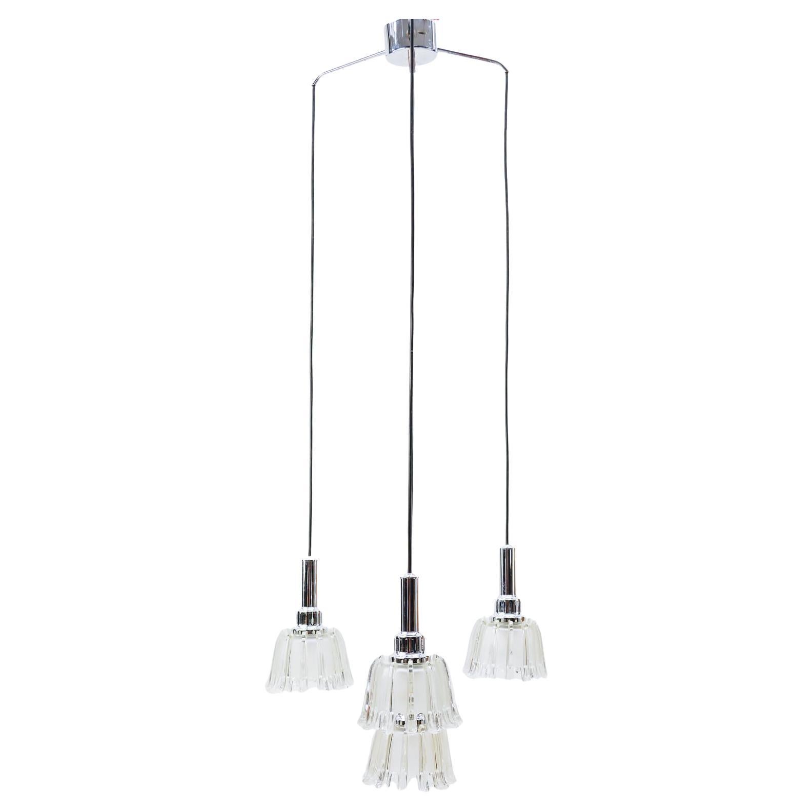 This ceiling lamp features a small frame with four cascading glass elements.

Fully functional. 

Four E27 sockets. Works with 220V and 110V.

Wiring is suitable for all countries.
