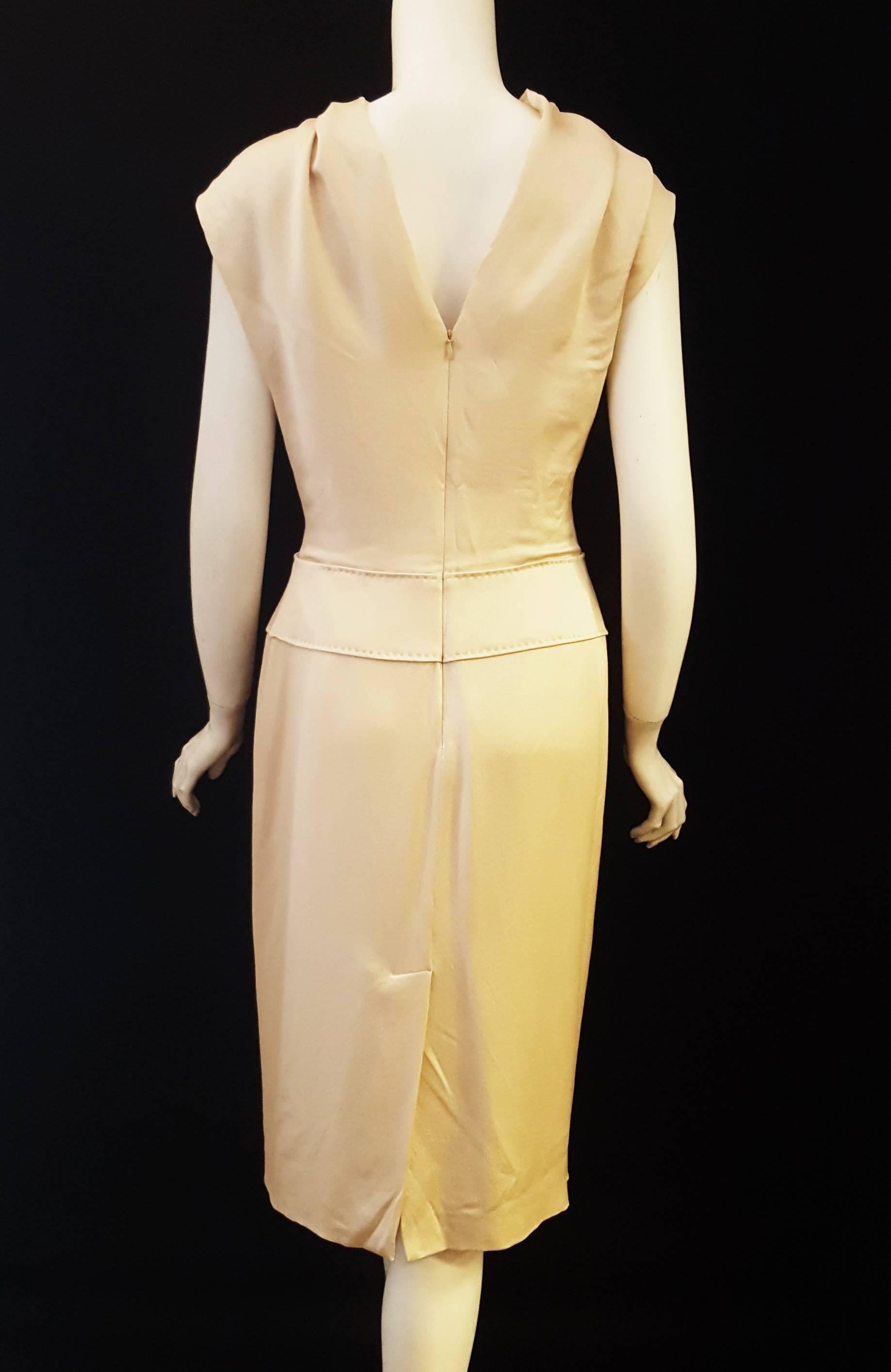 Stunning Alexander McQueen beige hammered silk dress features a partially exposed V back that terminates at the hidden zipper.  This interesting sleeveless dress with slight cowl neck is elegant and very current, the perfect all year long dress.  