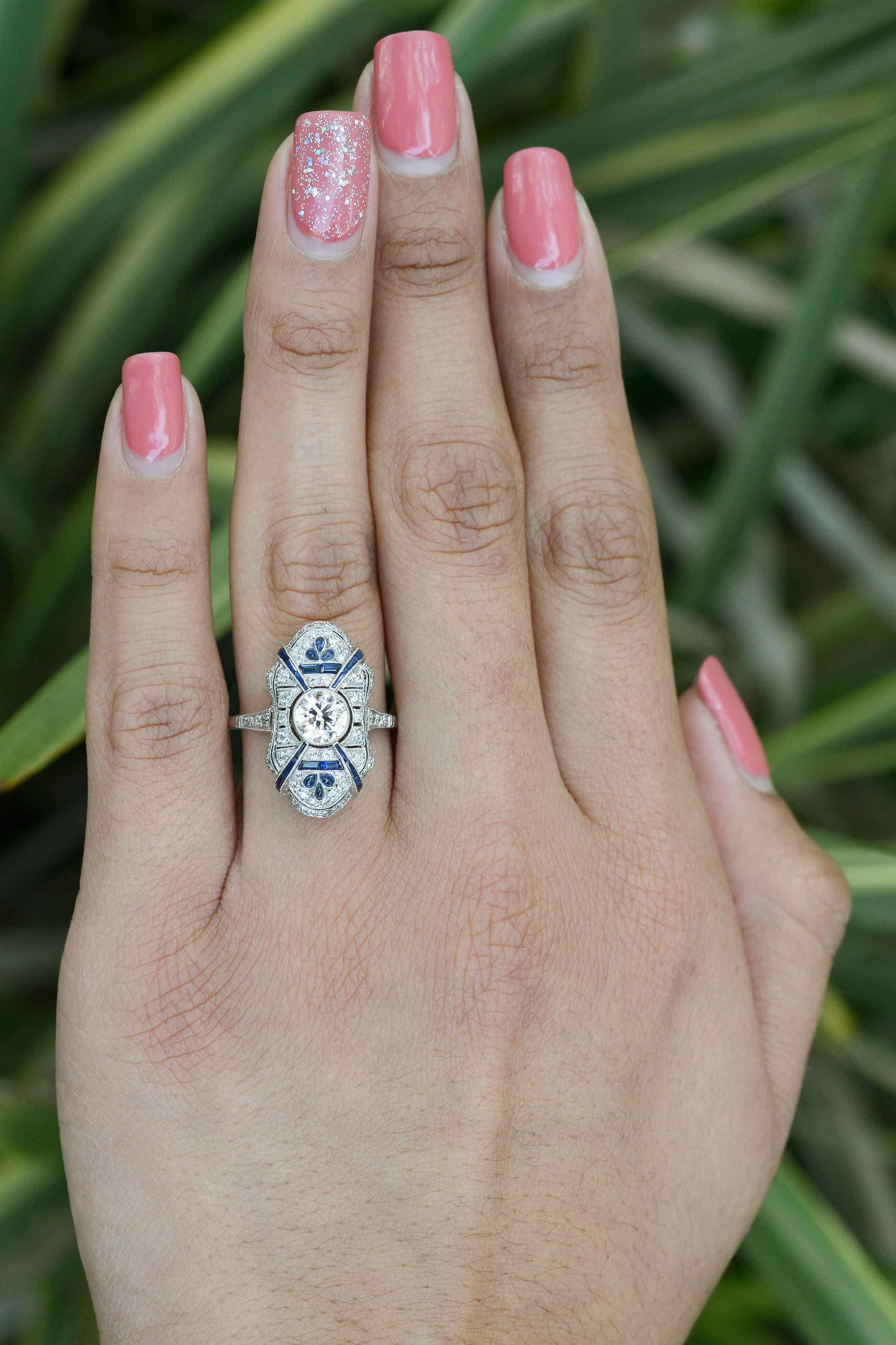 The Montgomery diamond Art Deco engagement ring. This design is also be an awesome long, sexy cocktail ring. Looking like Josephine Baker taking center stage, is a sparkling 3/4 carat brilliant diamond accented by radiating rays of French cut