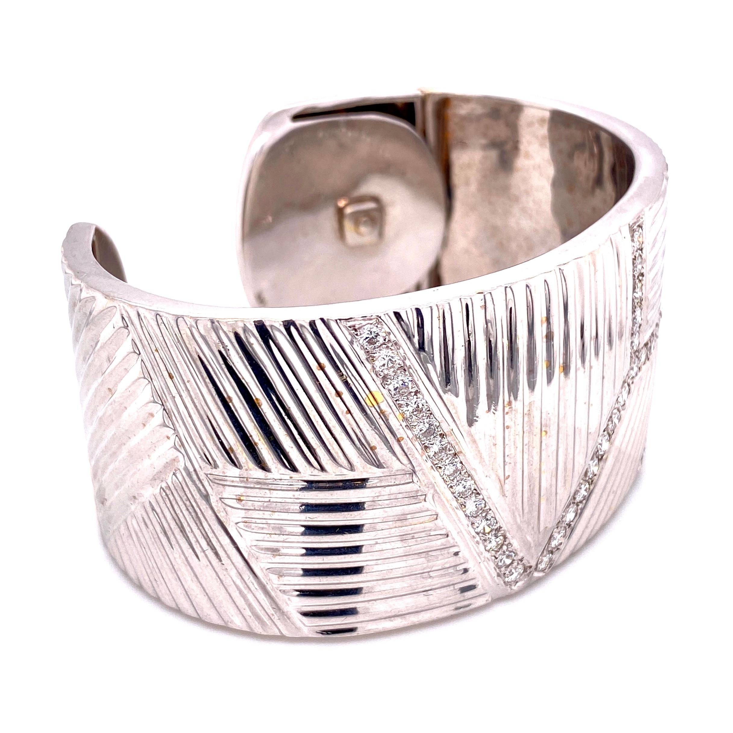 Simply Beautiful! Finely detailed Diamond Cuff Bracelet, approx. size: 1.25” wide. Featuring a Geometric design with Hand set Diamonds, weighing approx. 3.00tcw. Hand crafted in 14 Karat White Gold with hinged system for easy on and and off. Unique