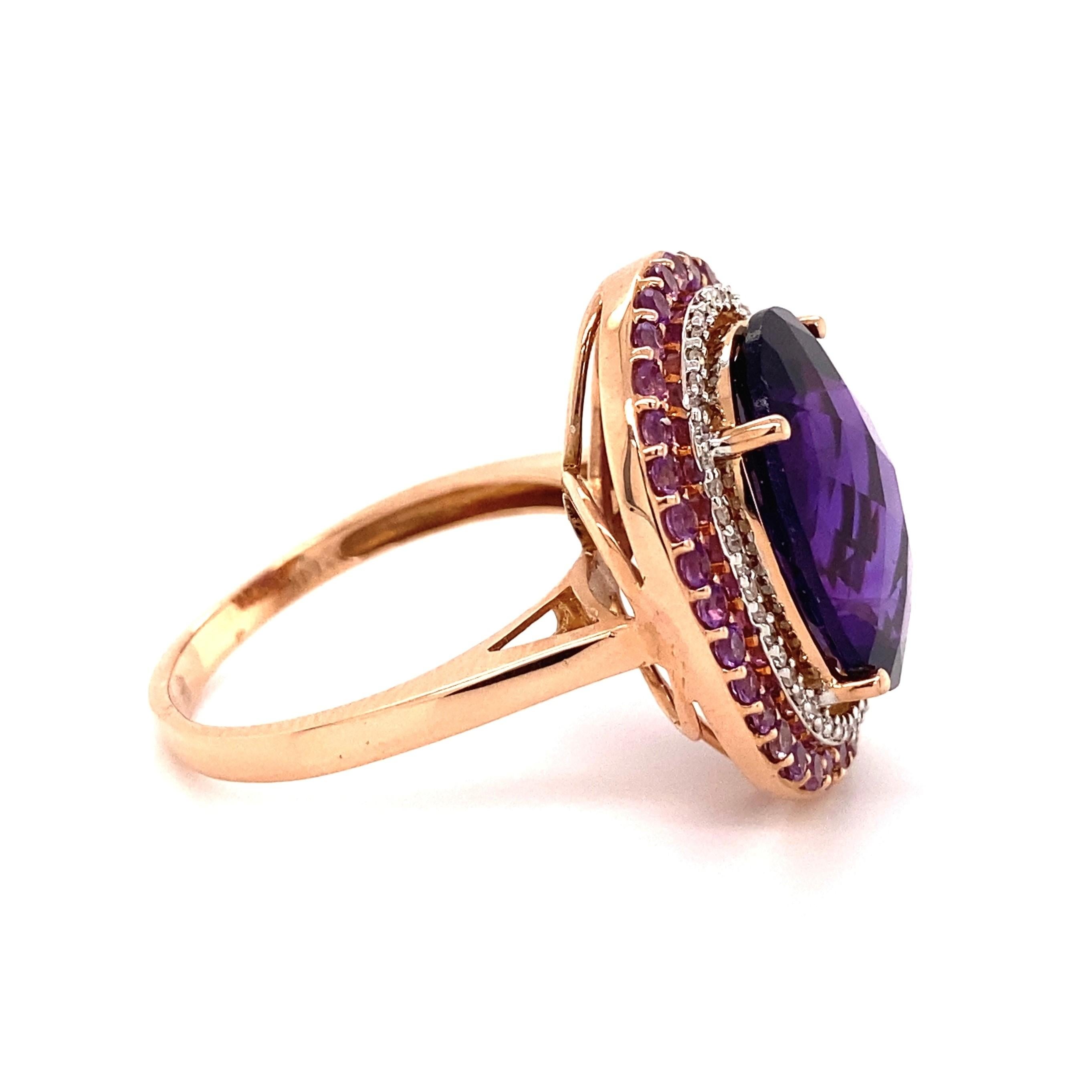 Amethyst and Diamond Cocktail Ring, securely centered by an Oval Amethyst, surrounded by Amethyst, approx. 12.24tcw and Diamonds, approx. 0.21tcw. Beautifully ‘wrapped’ Hand crafted 14K Rose Gold mounting. Approx. Dimensions: 1.43” l x 0.95” w x