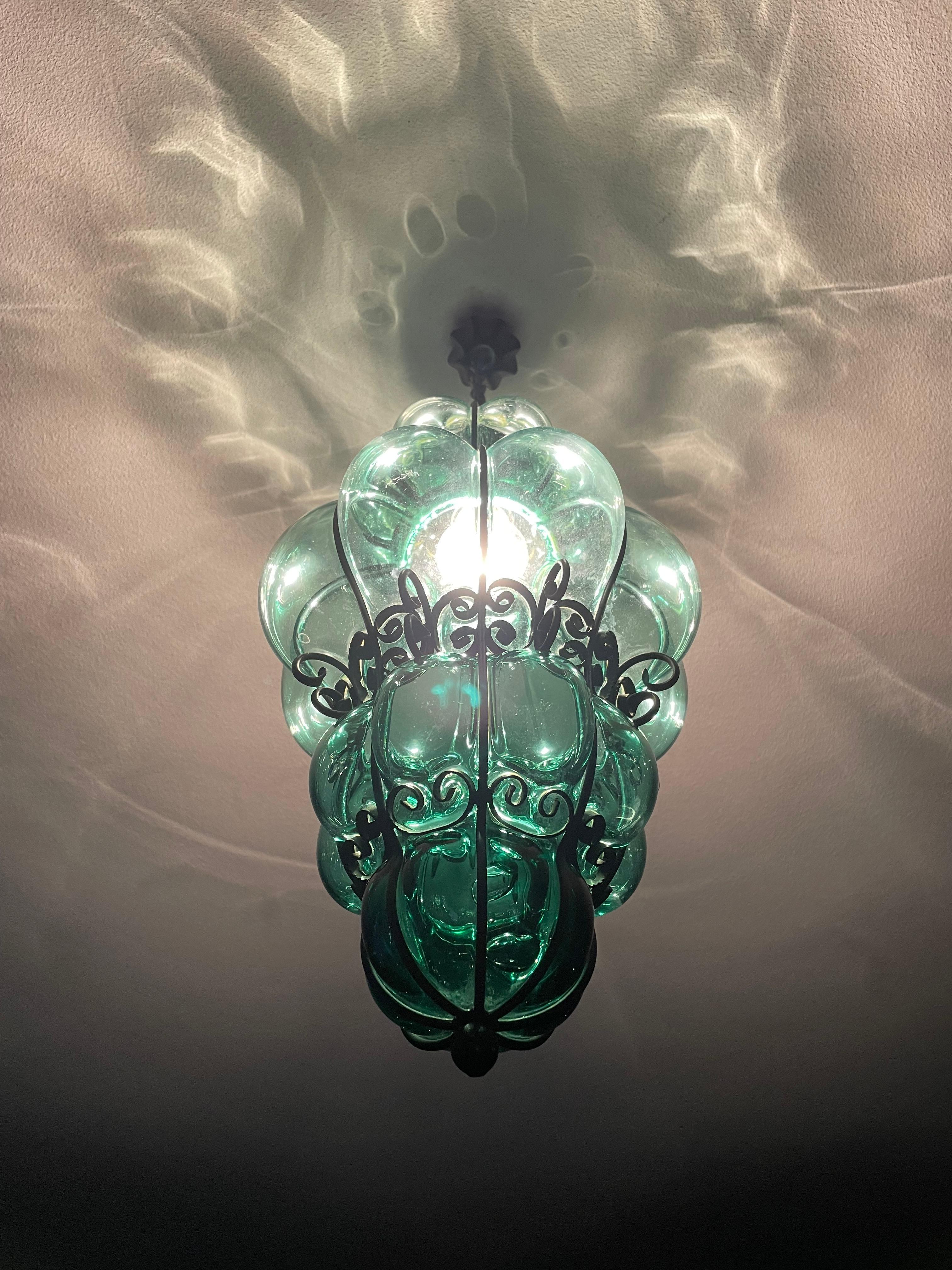 Beautiful color and practical size Italian fixture with mouth blown glass in a wrought iron frame. 

If you are looking for a rare and truly stylish Murano light fixture to grace your home then this handcrafted and semi-antique specimen could be