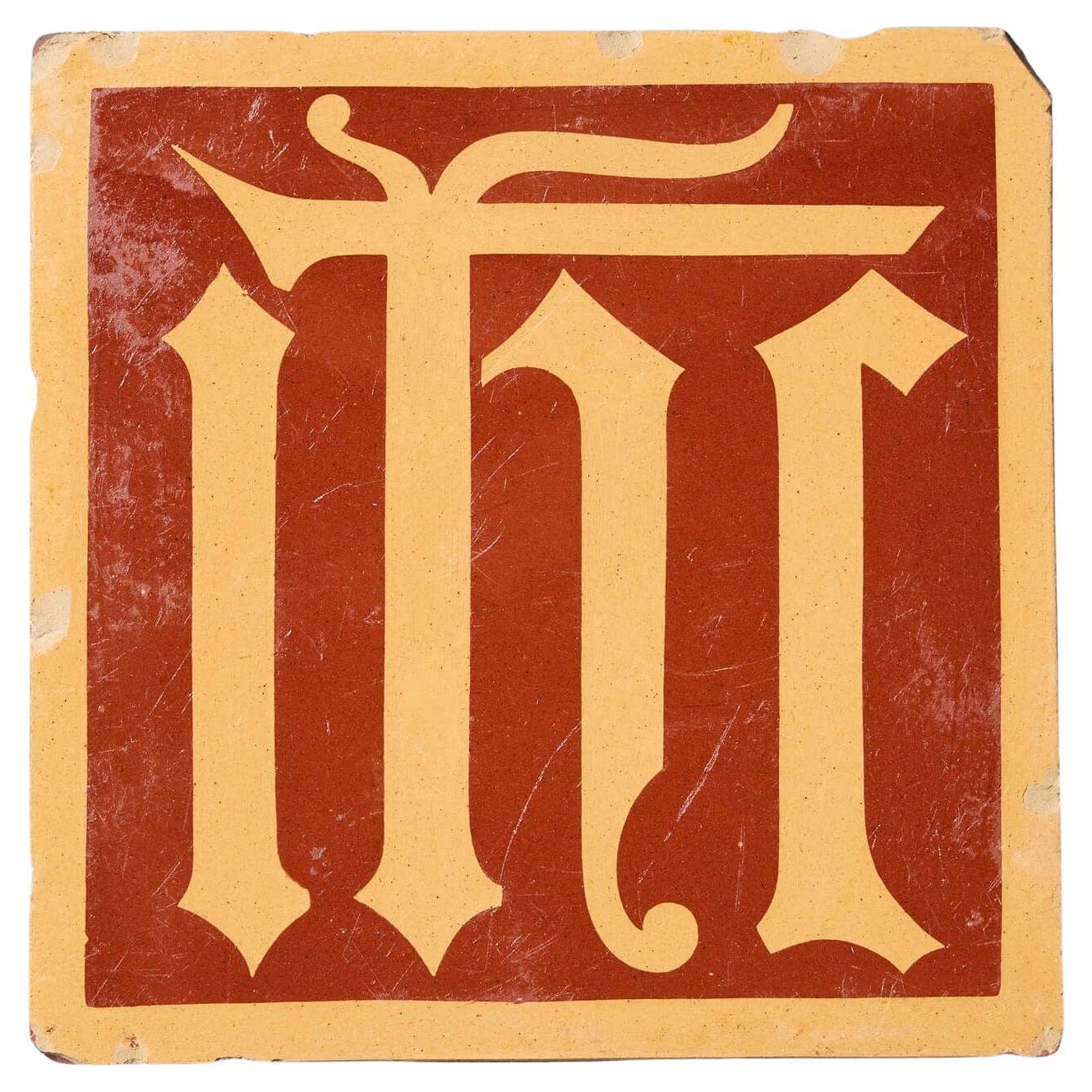 Piastrella Monogram di A.W.N. Pugin smaltata ad encausto di Minton & Co