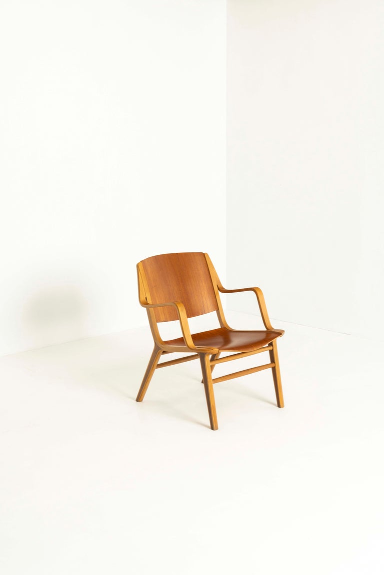 'Ax Chair' by Peter Hvidt & Orla Mølgaard Nielsen for Fritz Hansen from Denmark the 1950s. The chair is formed with laminated beechwood and the seat is made of hand-carved teakwood and veneered plywood. The chair is standing on four legs that