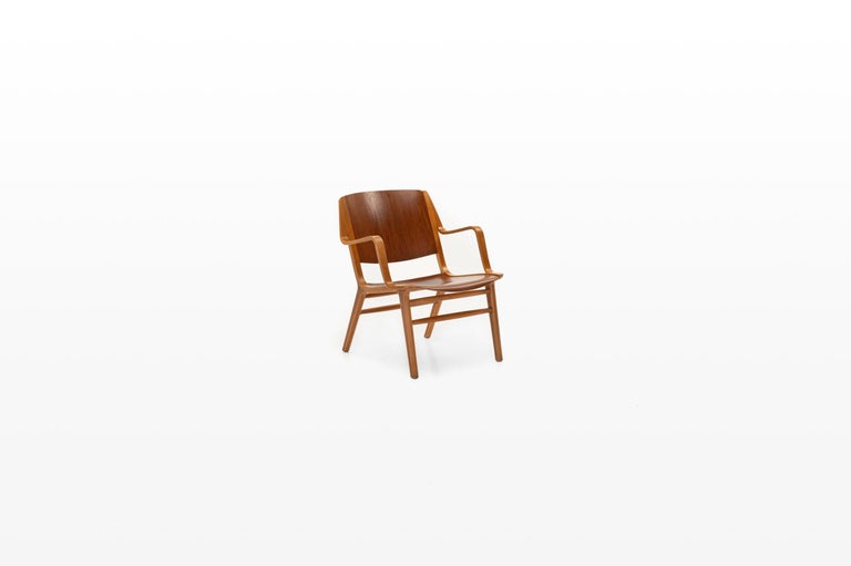 Ax chair designed by Peter Hvidt & Orla Molgaard Nielsen and produced by Fritz Hansen, Denmark 1950s. The chair is made of a combination of laminated beechwood and teak with a mahogany core. An example of this chair can be found at the Museum of