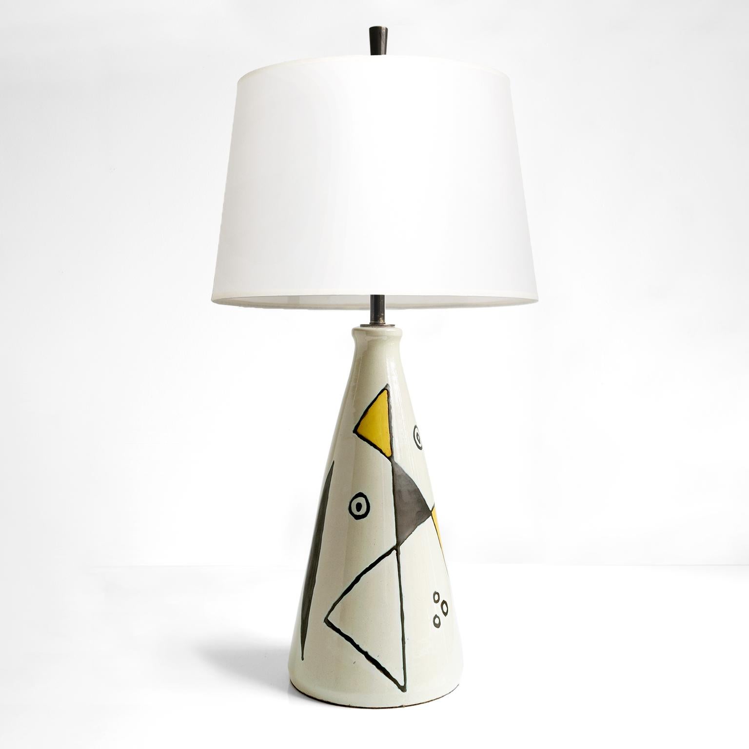 Axel Bruel, Scandinavian Modern glazed stoneware table lamp, Denmark. The lamp is decorated by Bruel in abstract shapes wrapped around a conical shaped body. Newly rewired with a patinated brass double cluster of edison base sockets. Finial is