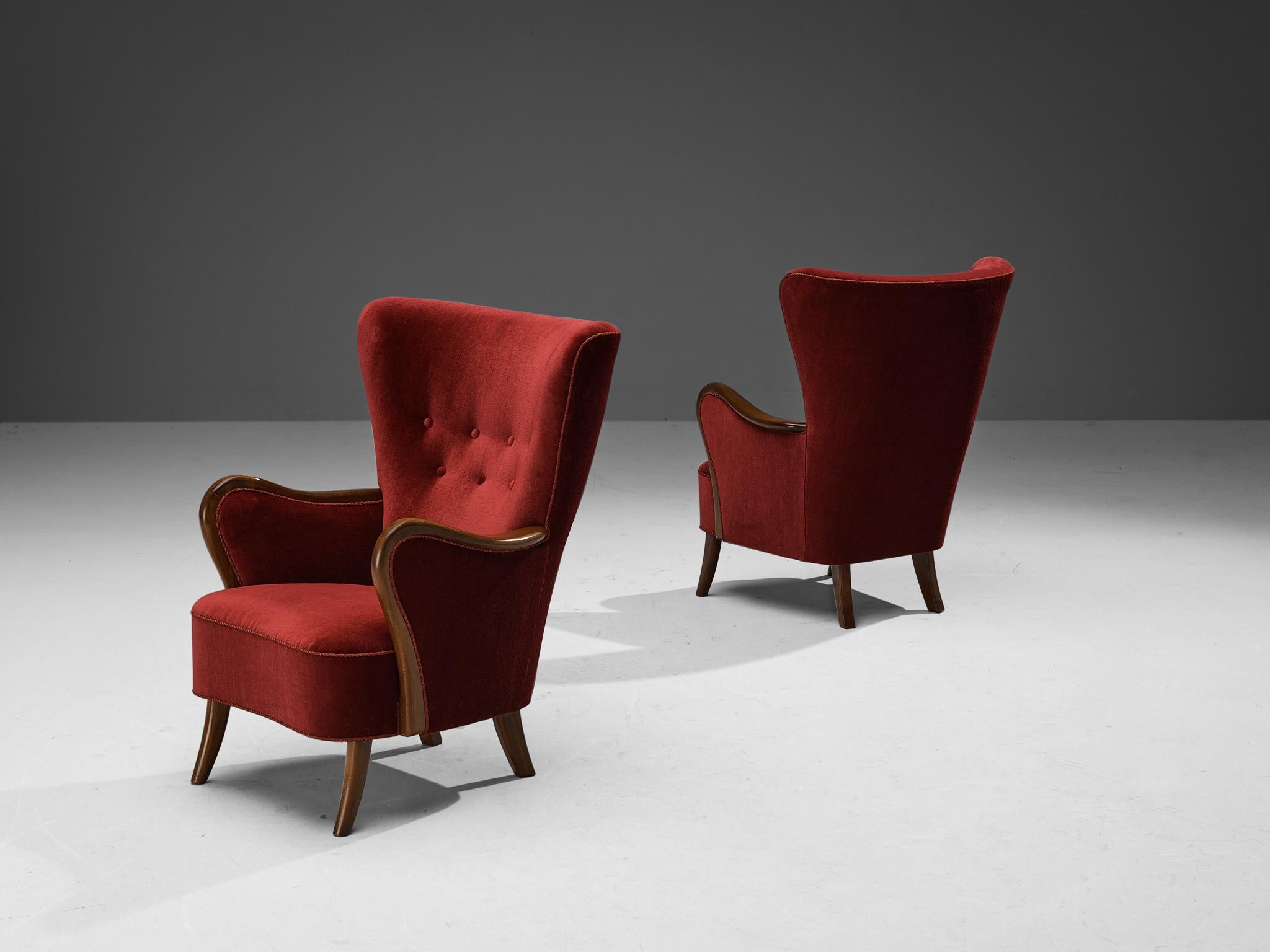 Axel Christensen, pair of lounge chairs, velvet, stained beech, Denmark, 1960s

These charming lounge chairs with their burgundy colored velour, soft edges and sturdy shapes, are typical for Danish design. The back develops in a modest winged