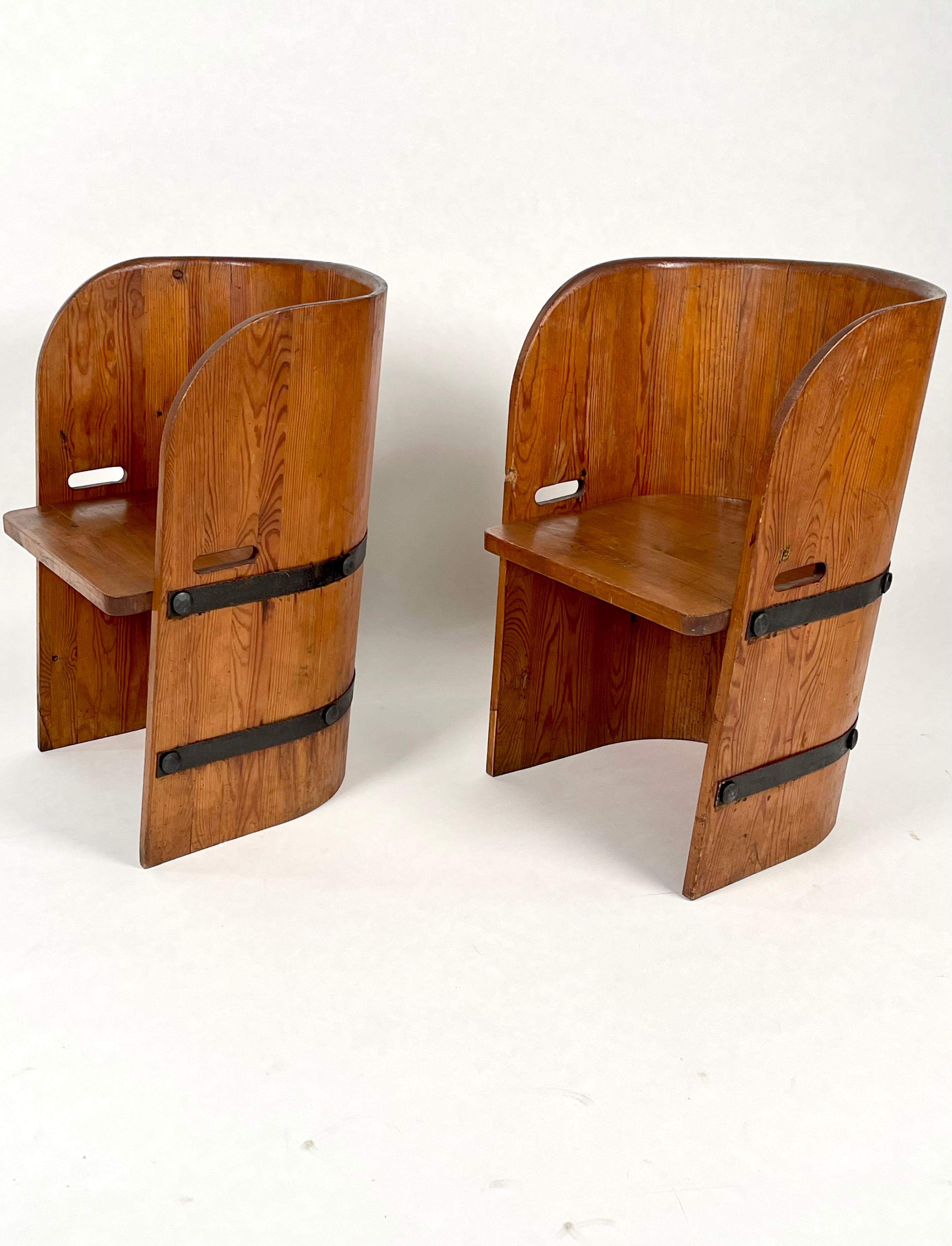 A pair of solid, acid stained pine & forged iron barrel back shaped sports cabin armchairs, Sweden 1930-1940s.
Attributed to Axel-Einar Hjorth, executed by Åby furniture, the company produced for Nordiska Kompaniet, in Stockholm. AEH was the NK