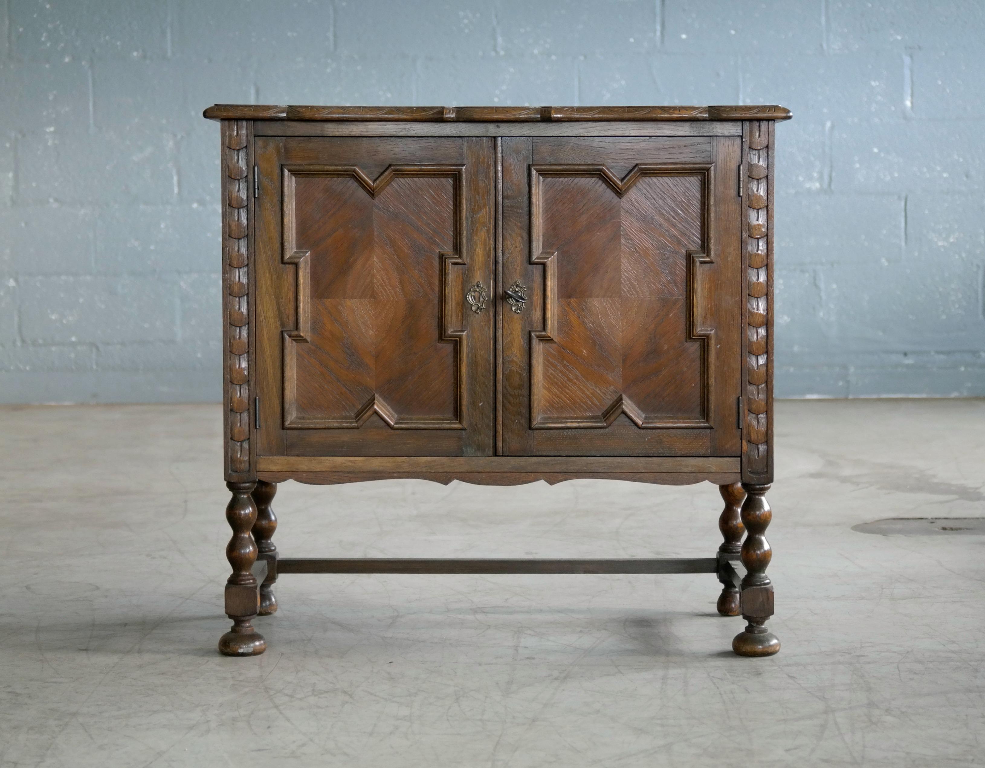 Beautiful small cabinet or console attributed to Axel Einar Hjorth and exemplifying his fine craftsmanship and recognizable design. Made from carved stained oak. The top has been professionally refinished. Made in Sweden circa 1940s. Unmarked.