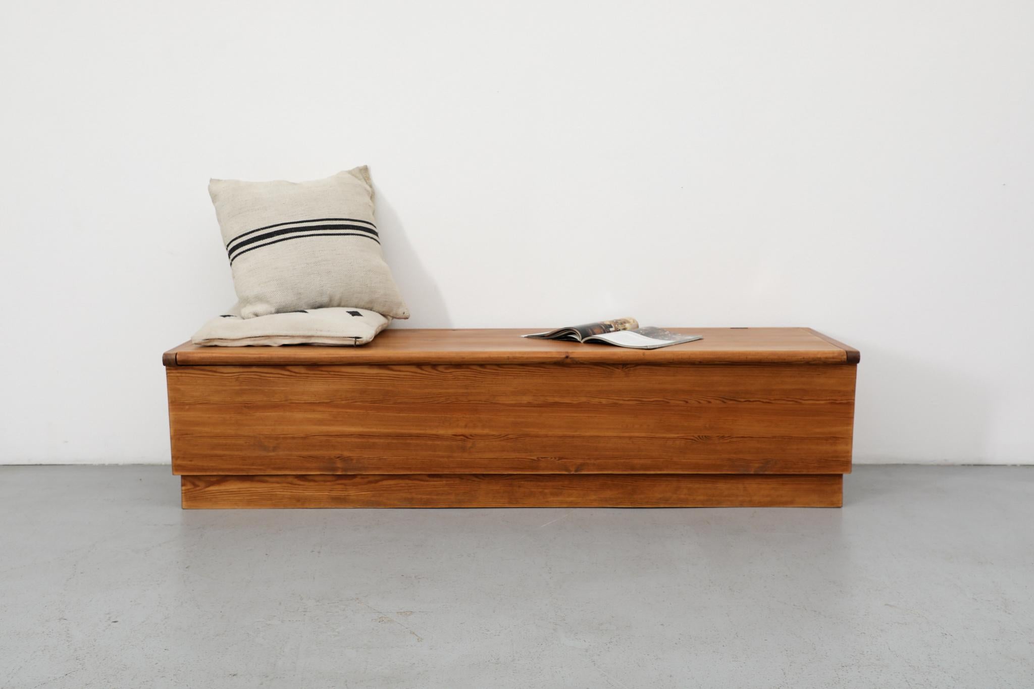Attributed to Swedish designer Axel Einar Hjorth (1888-1959), this large and robust pine storage bench is a striking example of his 'Sportstugemöbler' (Sports Cabin Furniture) series. This collection,designed for Nordiska Kompaniet, was created in