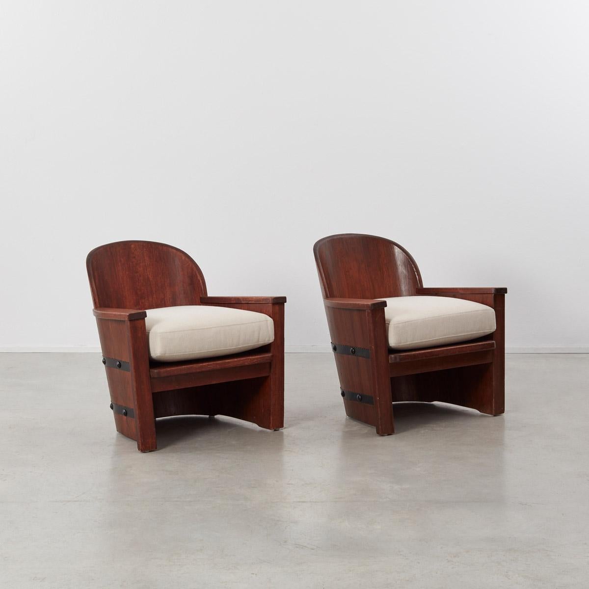 This pair barrel armchairs attributed to Axel Einar Hjorth are made of stained pine bound by studded iron bands. Axel Einar Hjorth was major contributor to the burgeoning Swedish design culture that was recognized internationally in the 1920s. He is